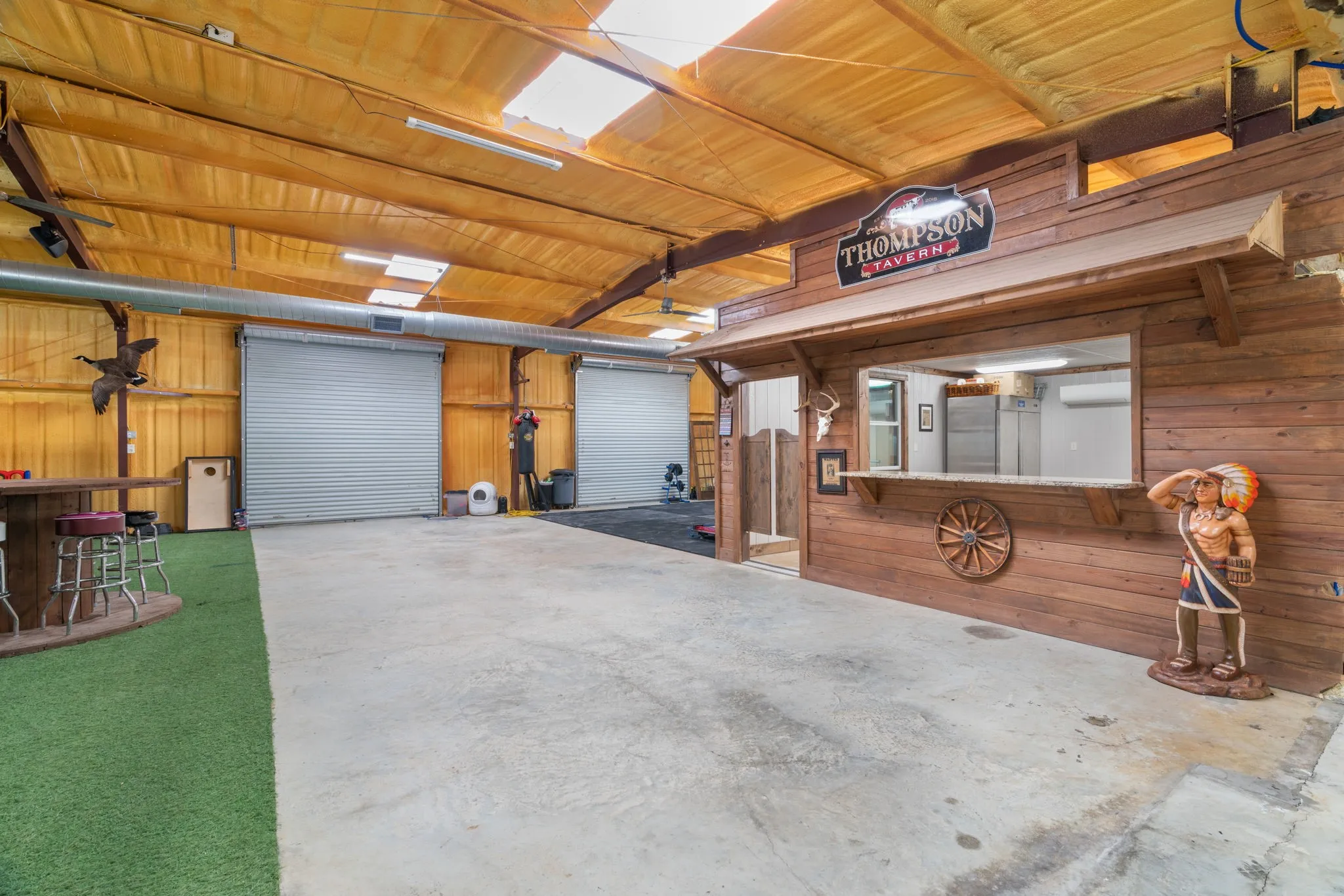 Large shop with high ceilings, garage doors and skylights