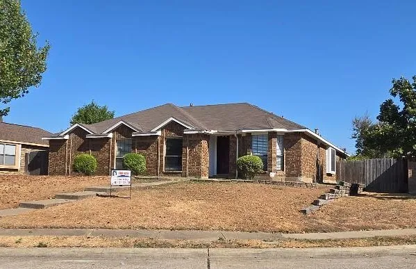 Brick exterior with gabled roofline and multiple bay windows