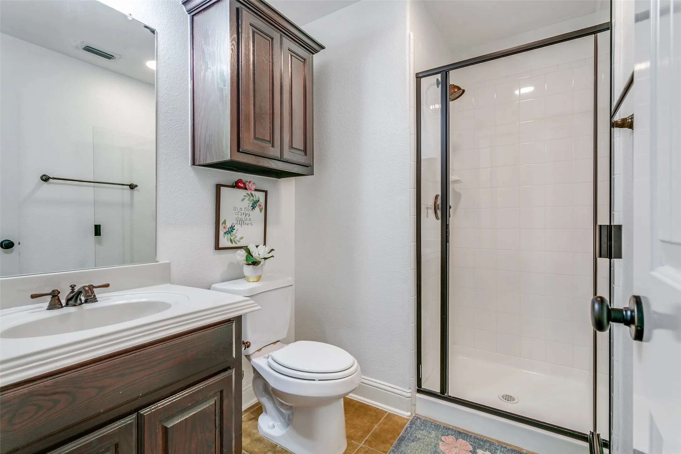 Wood-finish vanity with an integrated basin and white countertop