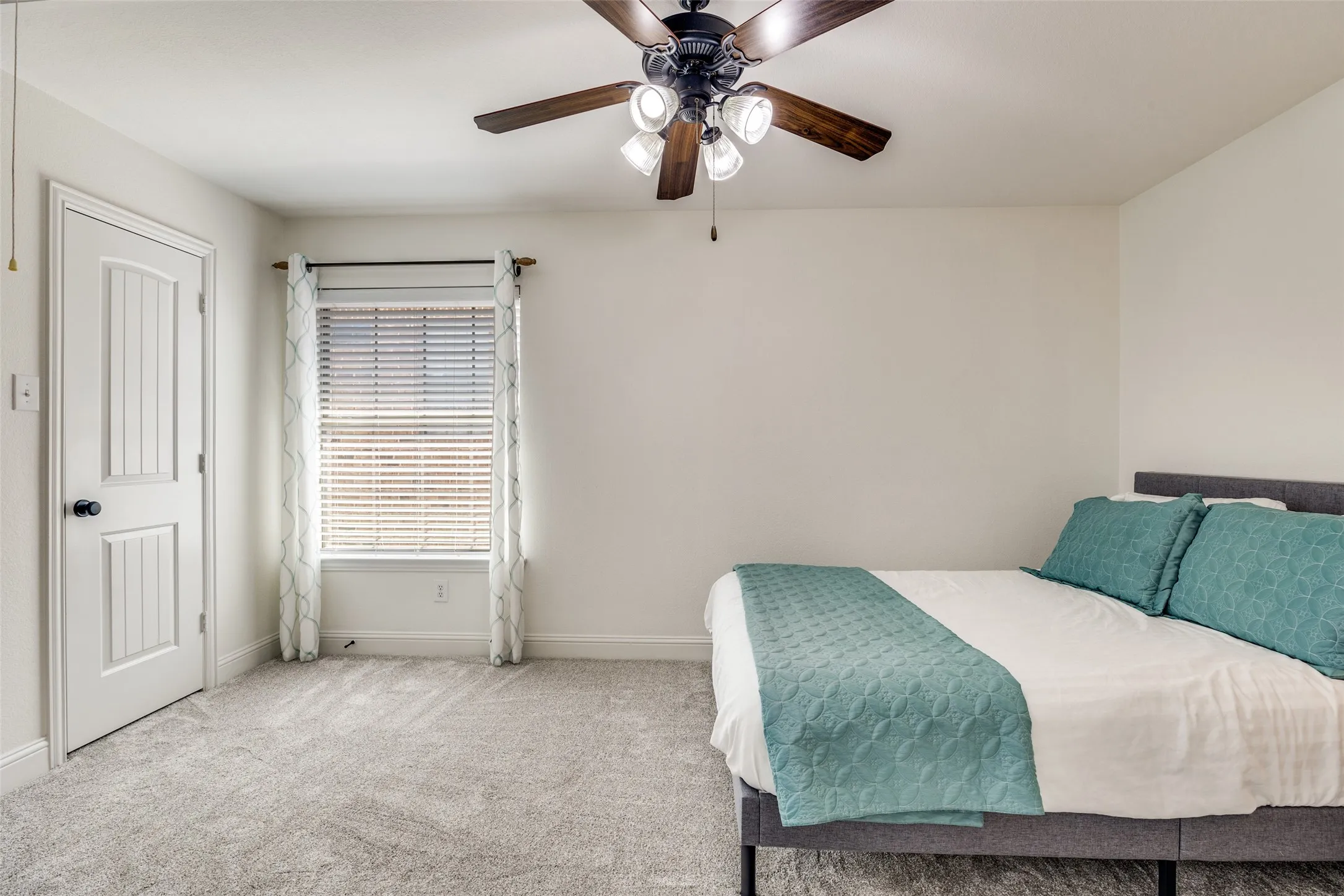 Neutral-toned walls complement the light grey carpeting
