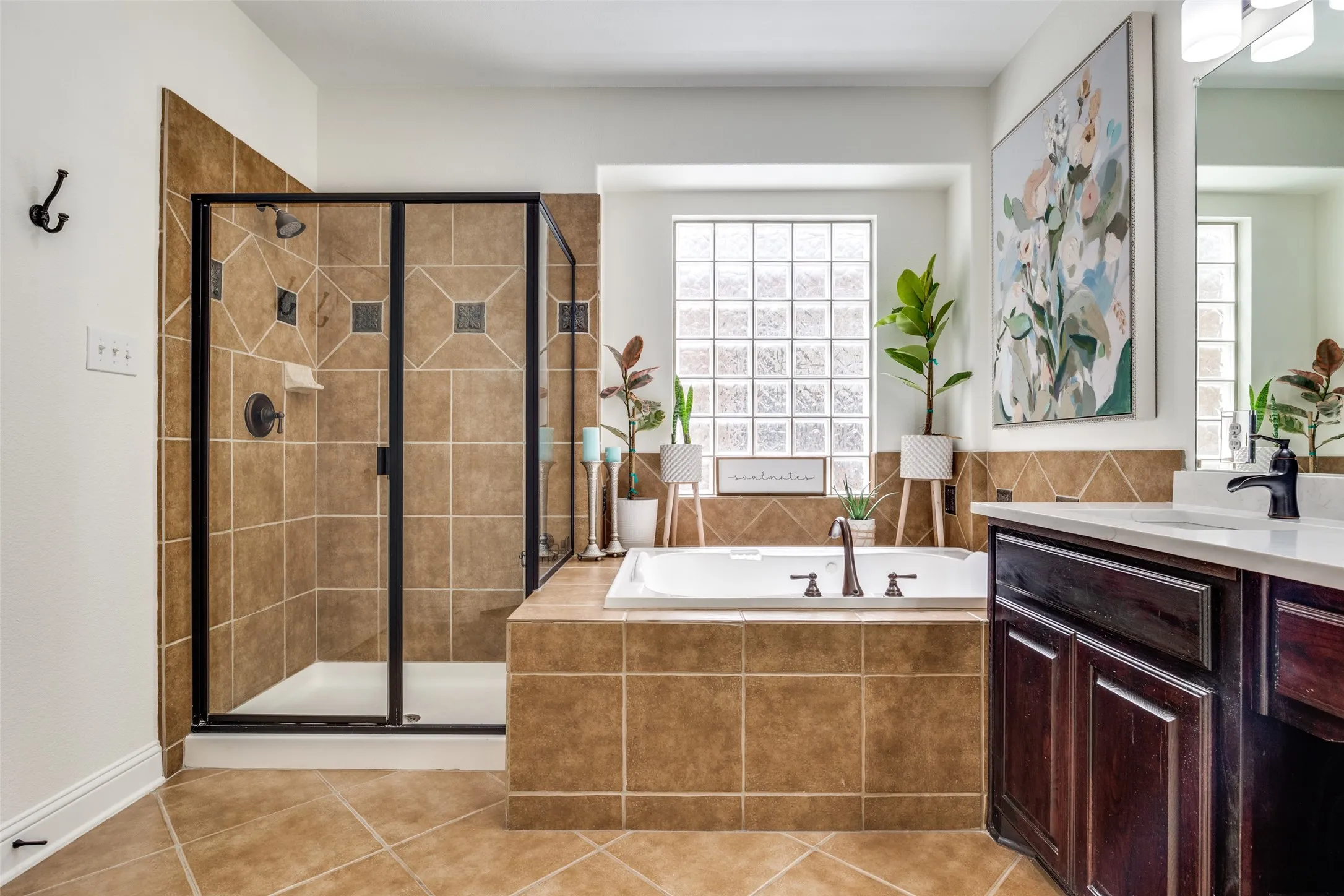 Tiled walk-in shower with a framed glass enclosure