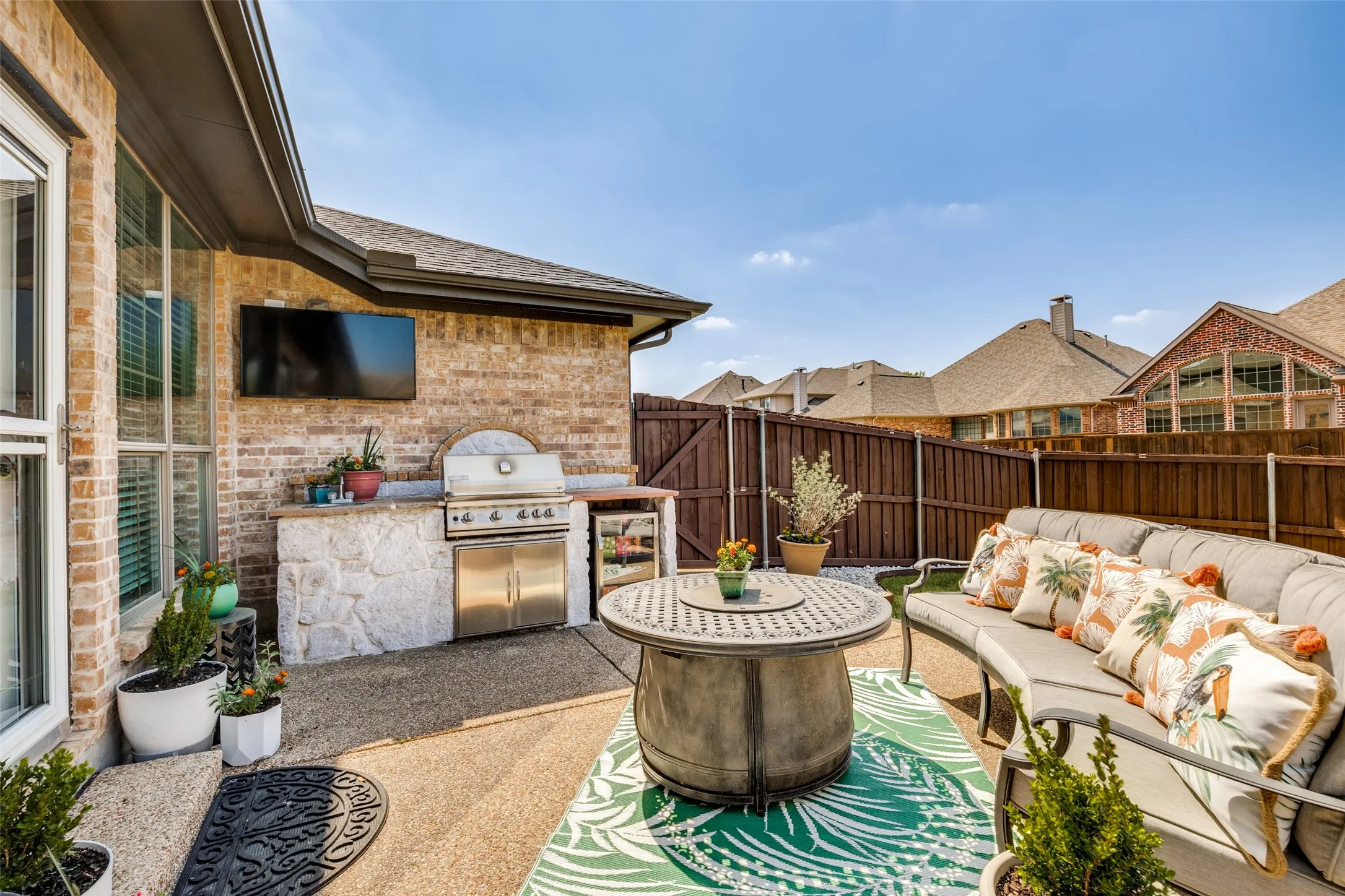 Outdoor kitchen with built-in stainless steel grill and refrigeration