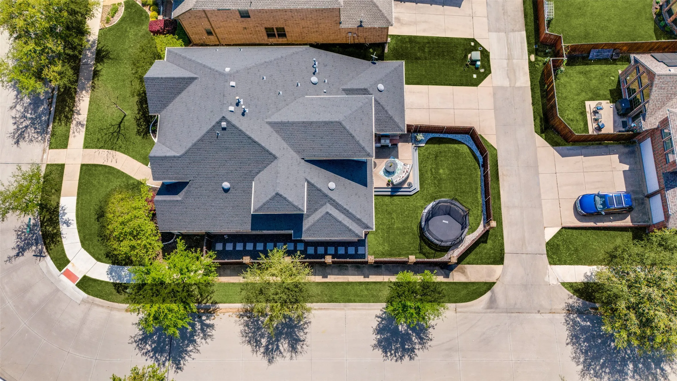 Expansive corner lot featuring a multi-gabled roofline and a well-maintained lawn