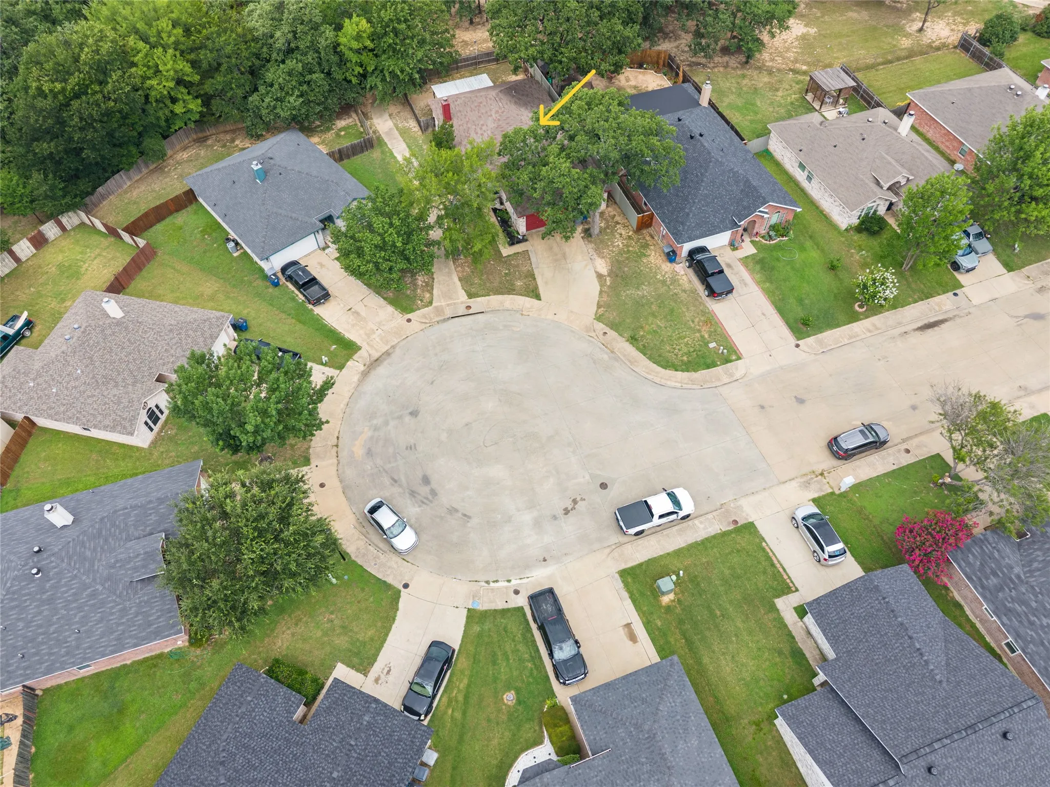 Cul-de-sac lot featuring a two-car driveway and mature trees