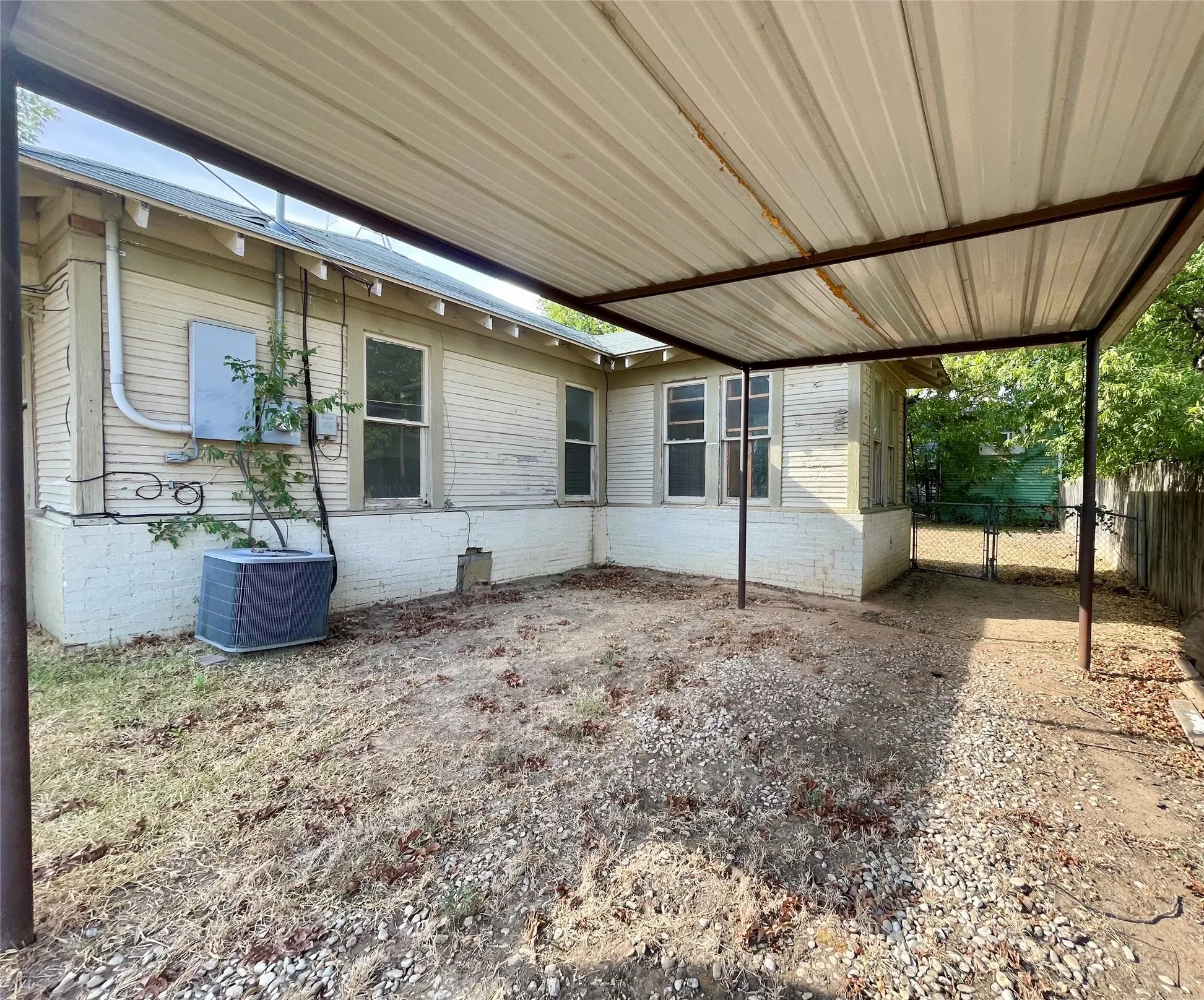 Detached carport, side of home, gates to backyard