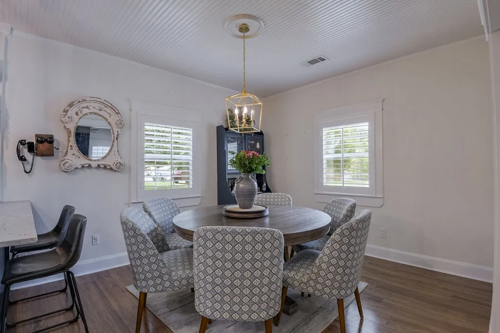Beadboard ceiling, wood-finish flooring, white plantation shutters, and a decorative ceiling medallion