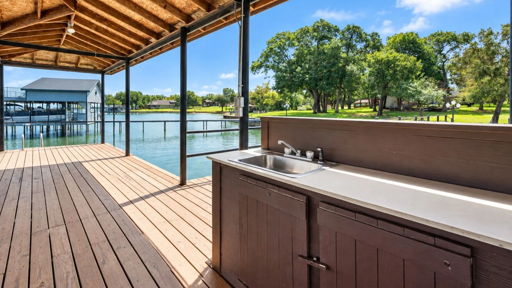 Covered private dock with generous deck space, and relaxing lake views just steps from this Streetman, Texas lakefront home.