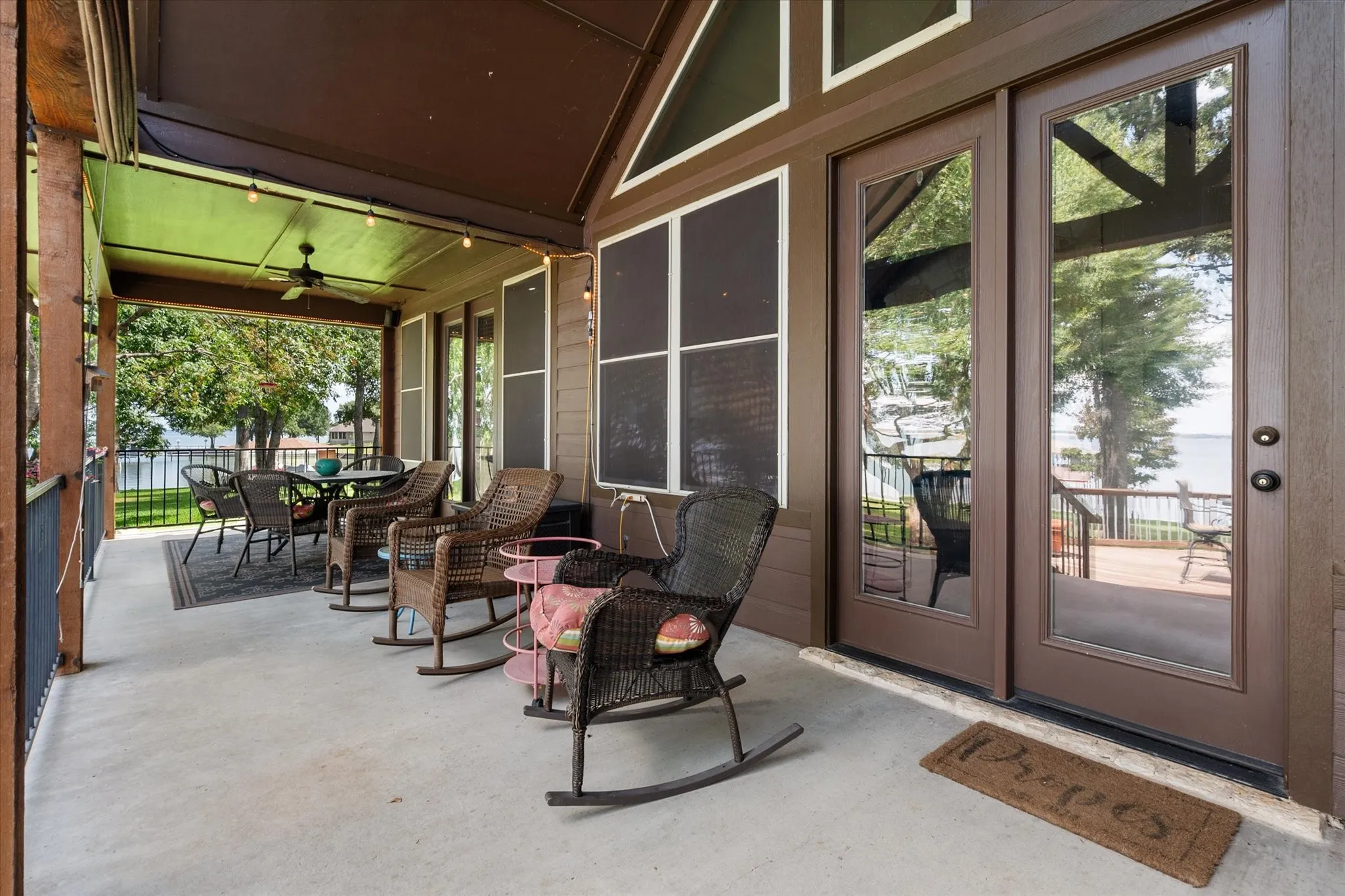 Shaded covered patio offers a relaxing place to enjoy the mature trees, backyard, and waterfront surroundings.