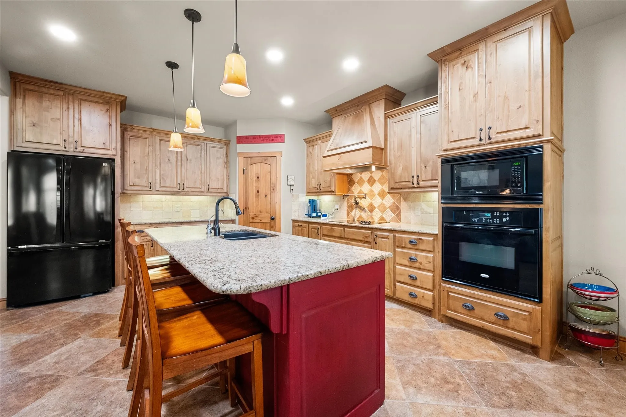 Open kitchen provides an expansive island, abundant cabinetry, and easy flow into the home's soaring great room.