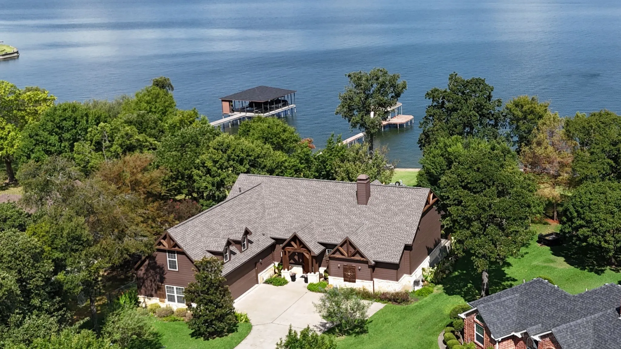 Front exterior view showcases the Craftsman-inspired architecture, attached garage, mature landscaping, and generous driveway.