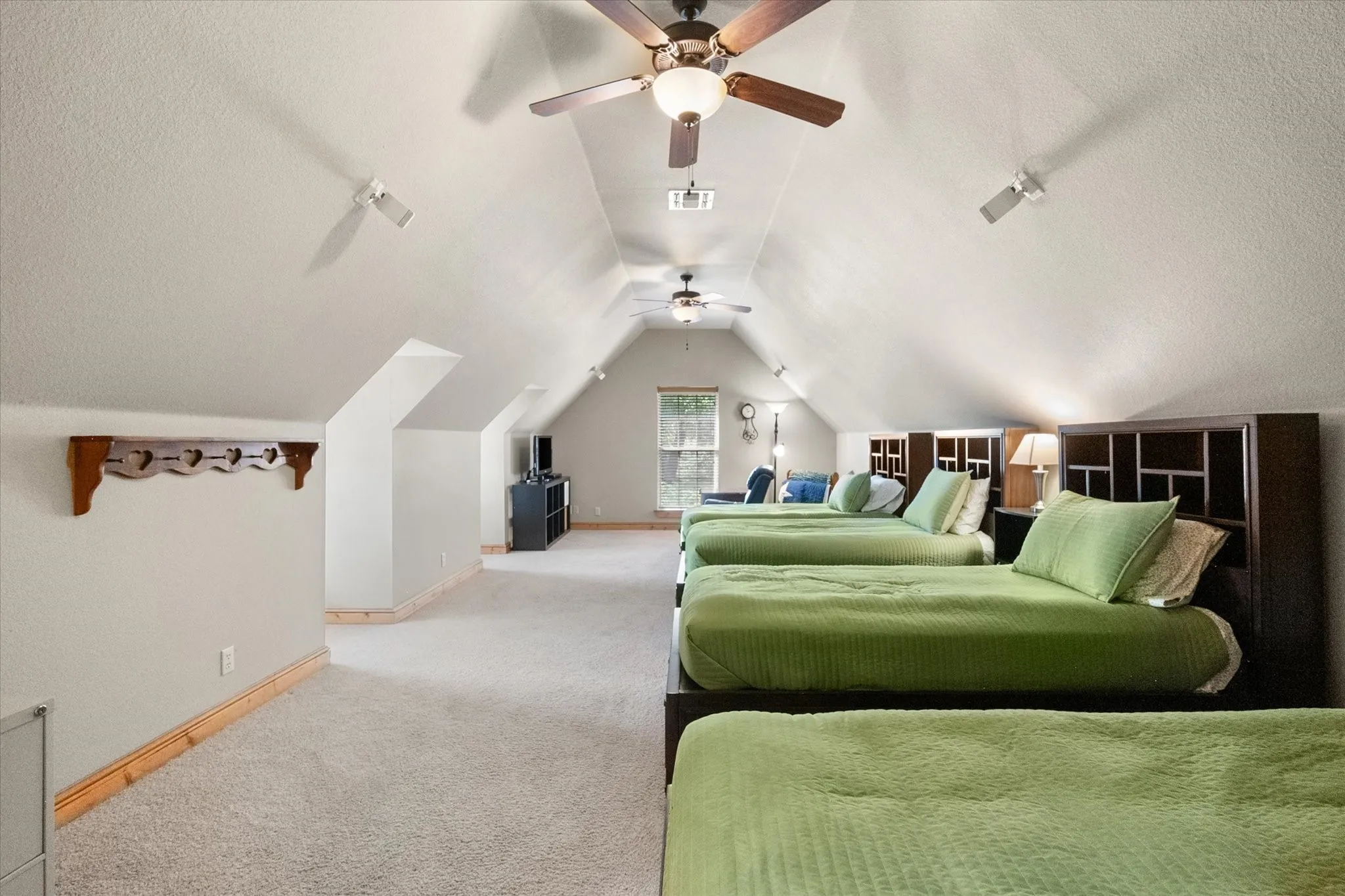 Spacious upstairs bonus room offers flexible additional living space with a vaulted ceiling and plenty of room for recreation or guests.
