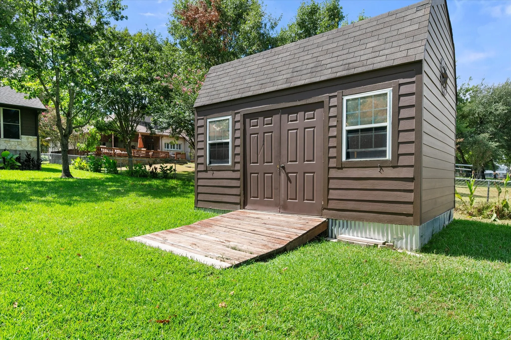 Detached backyard storage shed provides useful space for lake gear, lawn equipment, tools, and other outdoor essentials.