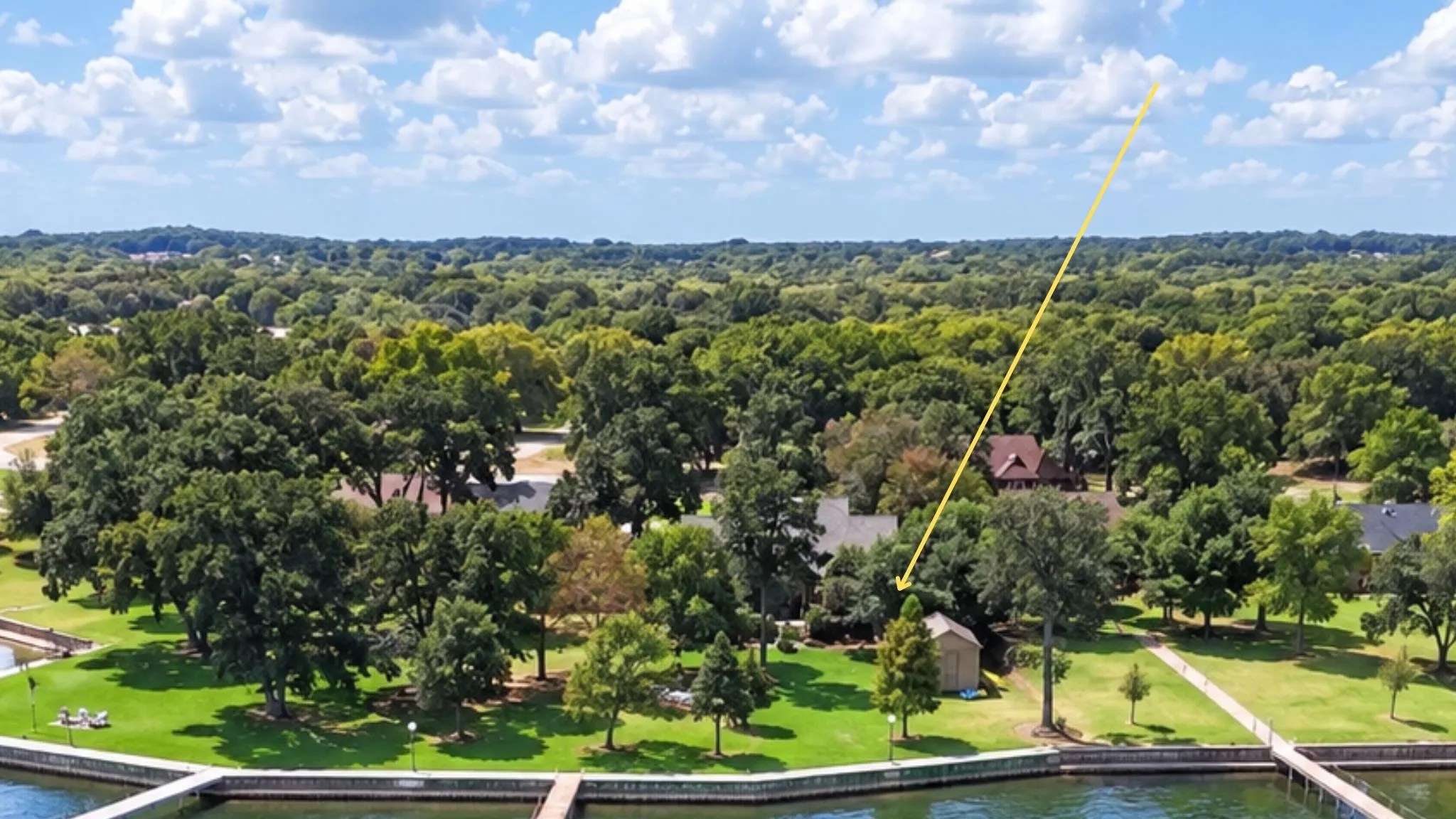 Mature trees frame the expansive backyard and rear elevation, enhancing the peaceful waterfront atmosphere of this lake property.