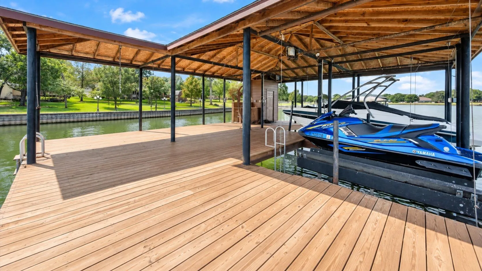 Substantial covered boathouse and boat slip provide convenient lake access from this waterfront Streetman property.