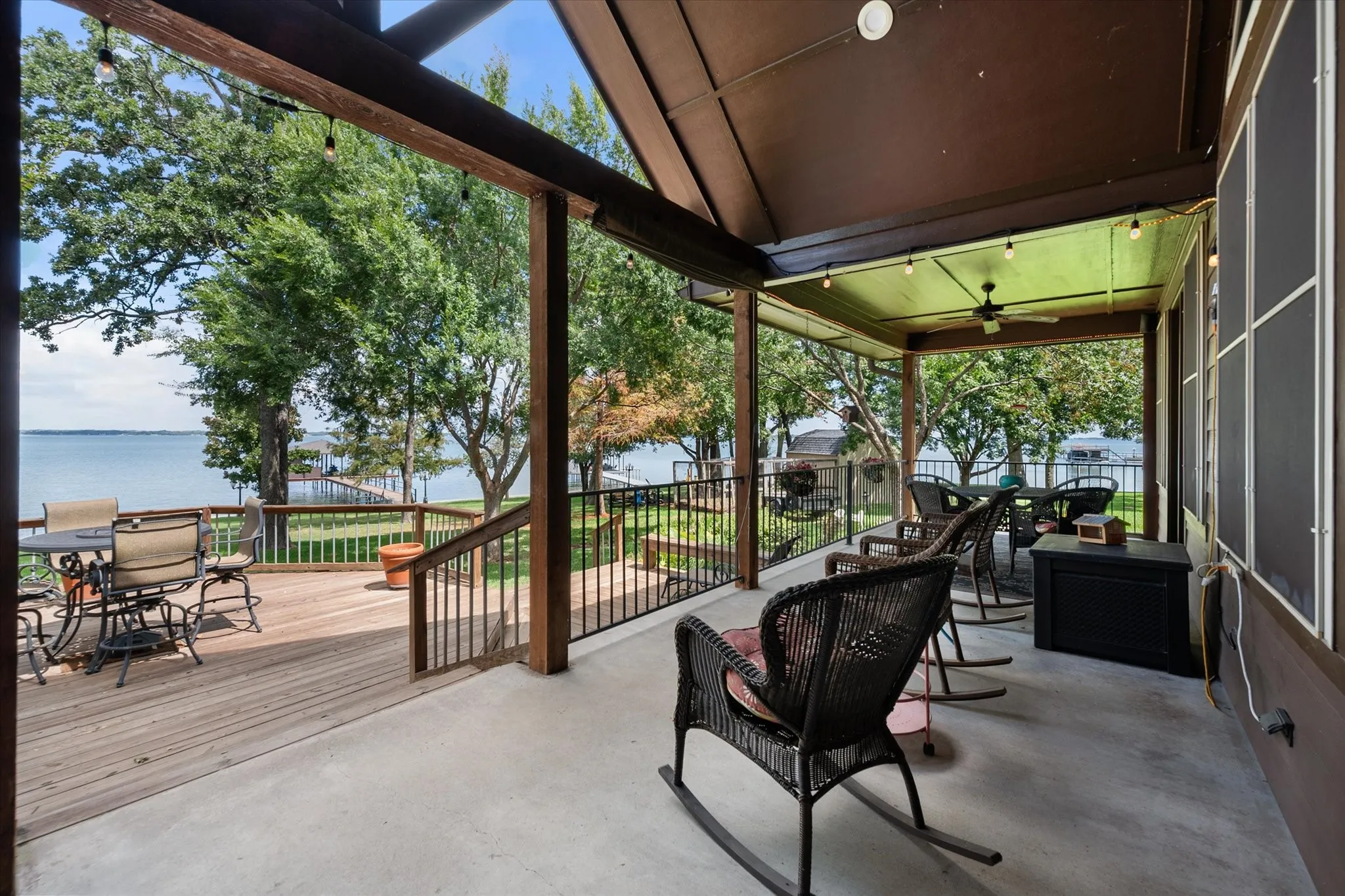 Covered outdoor entertaining area features generous deck space, built-in grilling amenities, and beautiful views toward the waterfront.