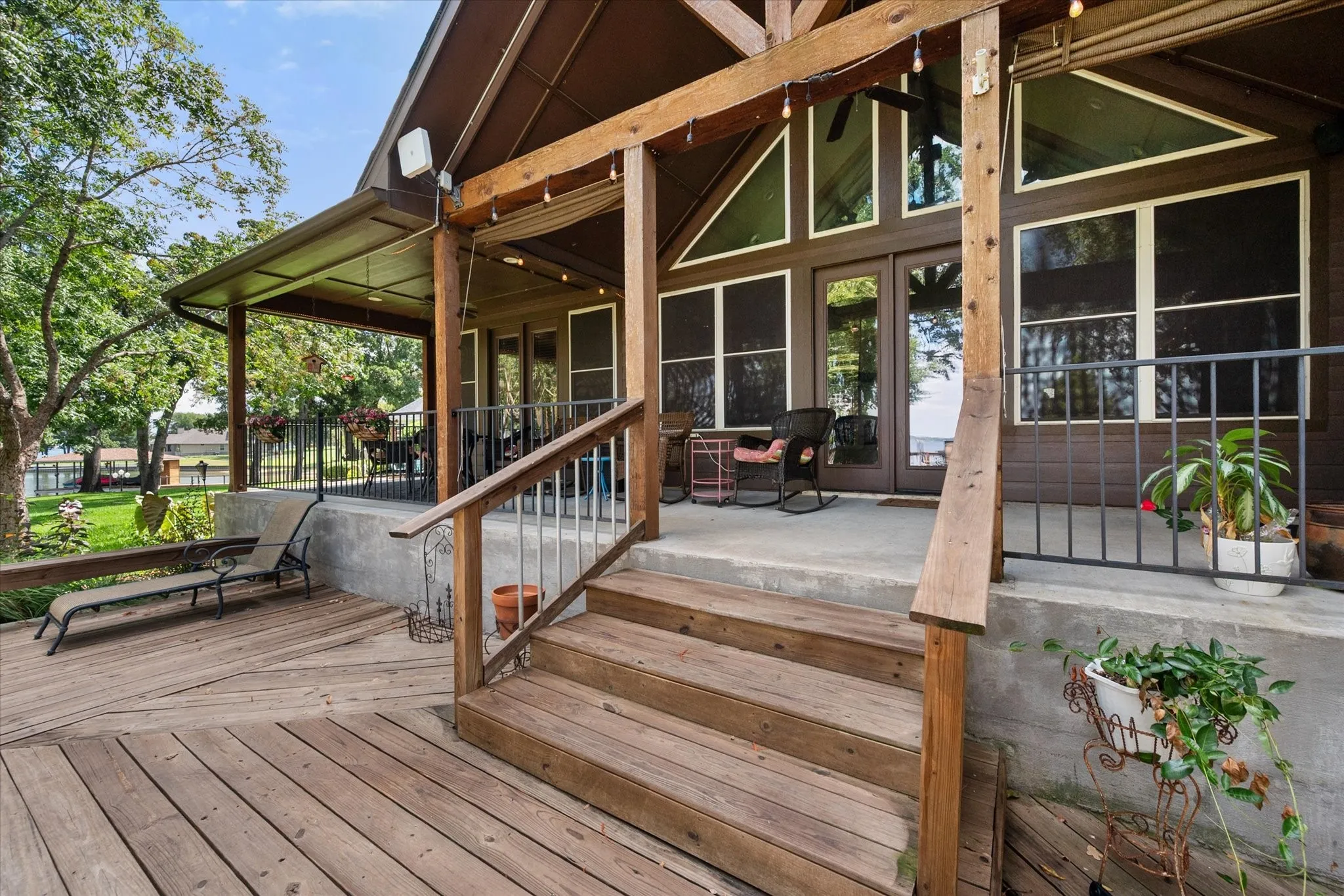 Covered rear deck showcases the home's Craftsman architecture while providing substantial shaded space for outdoor lakefront living.
