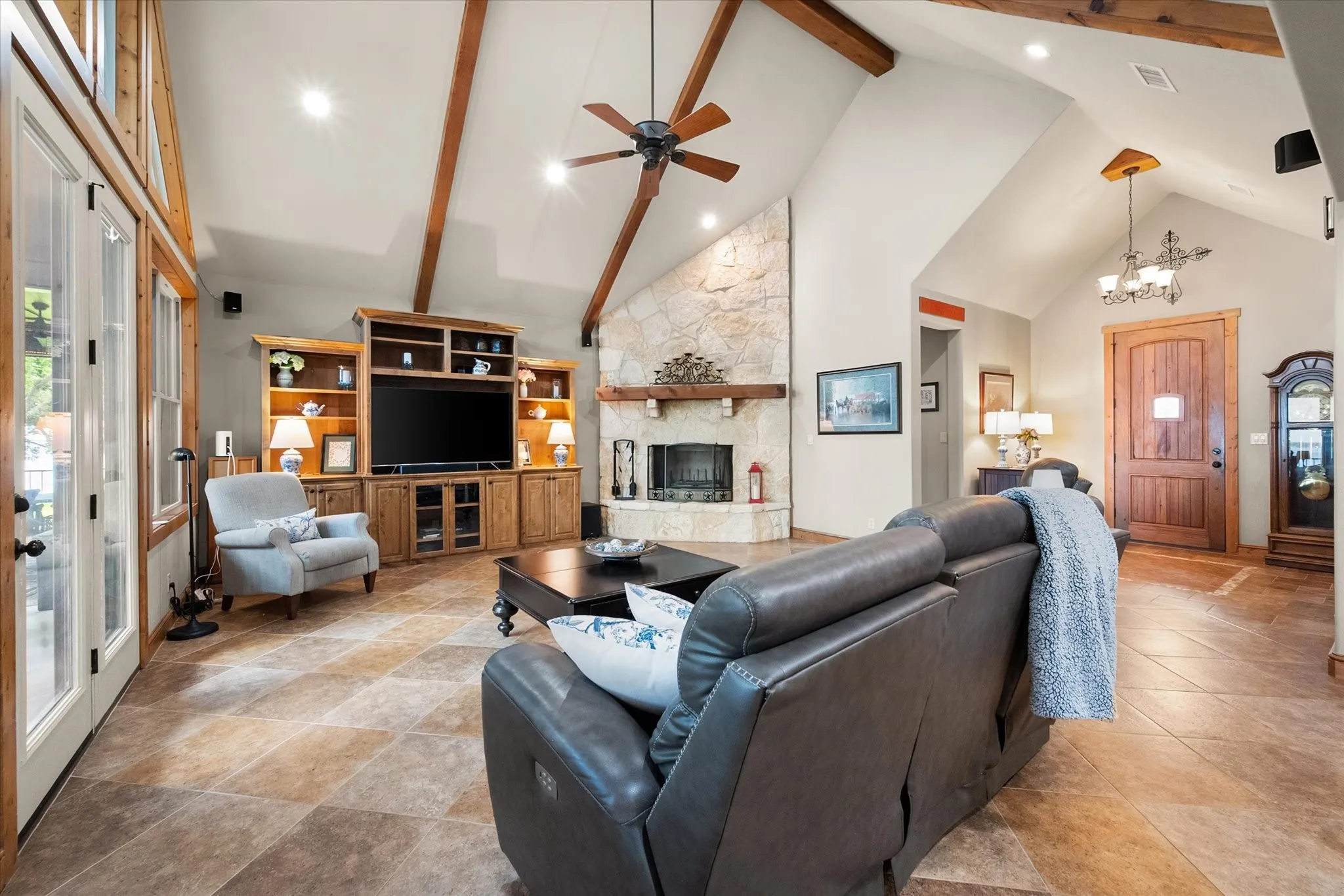 Open-concept living area offers generous gathering space with cathedral ceilings and seamless flow into the kitchen and dining areas.