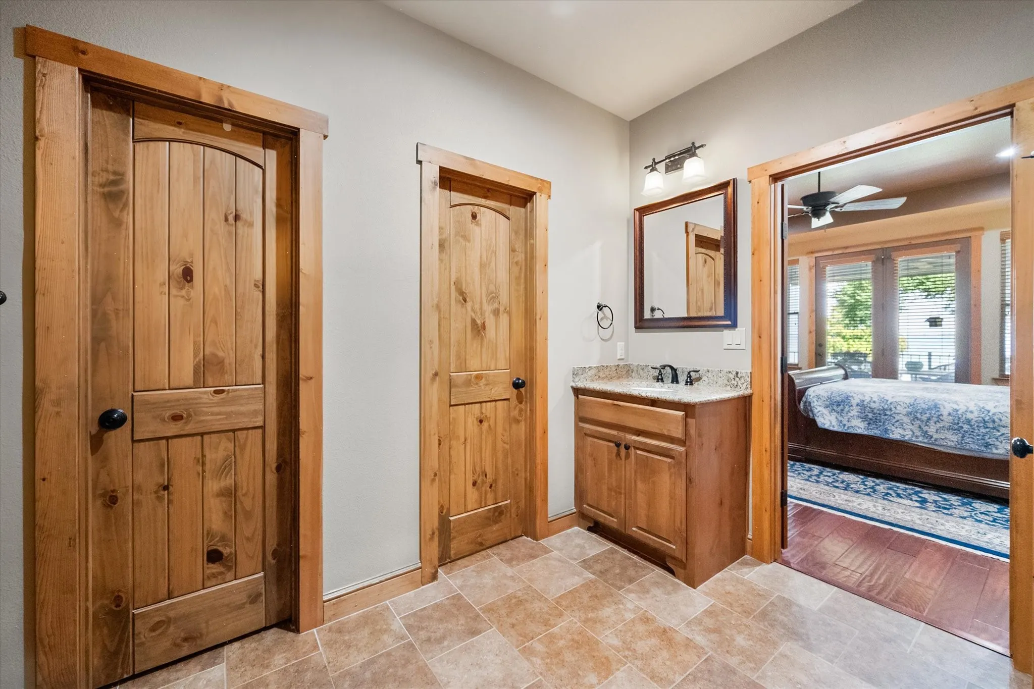 Natural wood doors and cabinetry add warmth and Craftsman character to this thoughtfully designed Streetman lake home.