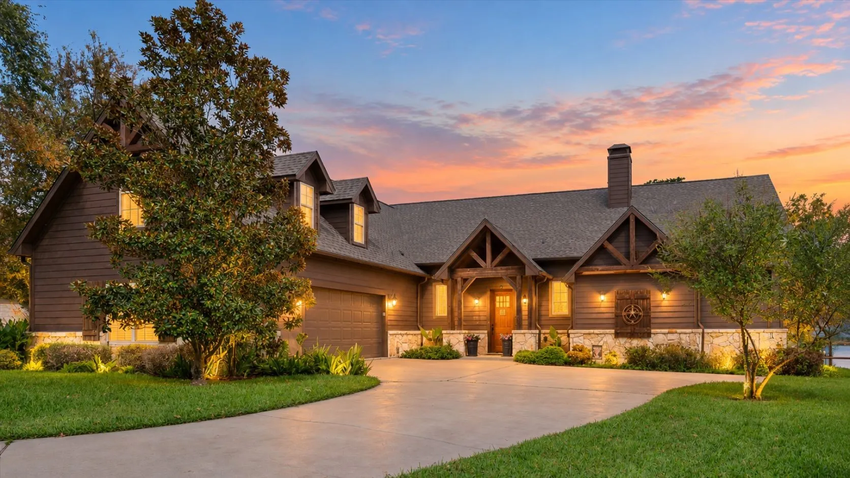 Twilight curb appeal highlights the warm Craftsman architecture, welcoming entry, mature landscaping, and spacious driveway at 5042 Loper Circle.
