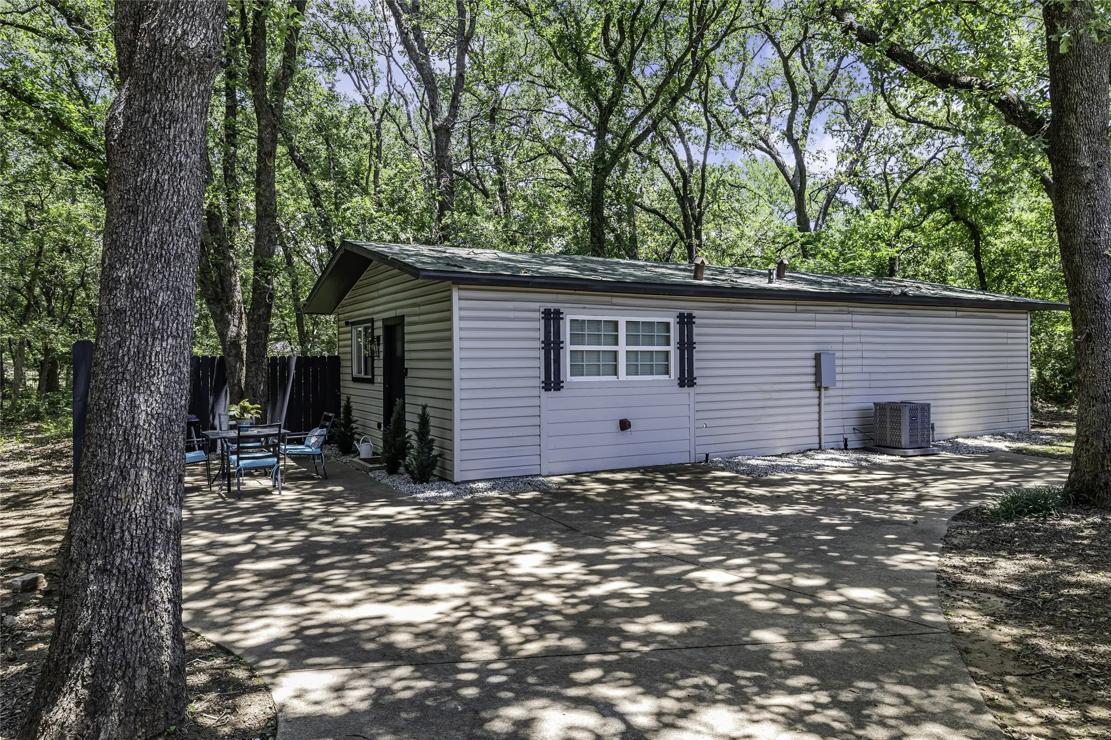 View of side of property featuring a cooling unit