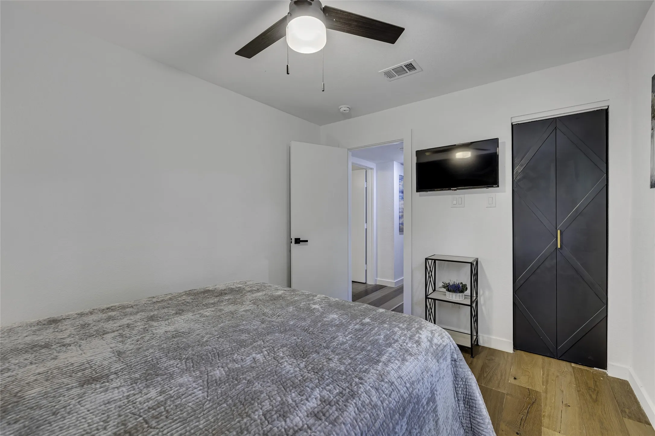 Bedroom featuring wood finished floors and ceiling fan