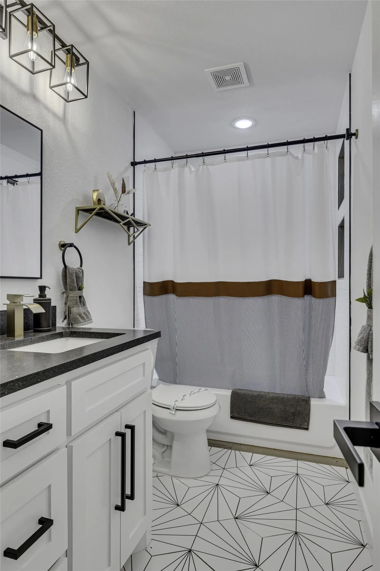 Bathroom featuring vanity, light tile patterned floors, shower / bath combo with shower curtain, and recessed lighting