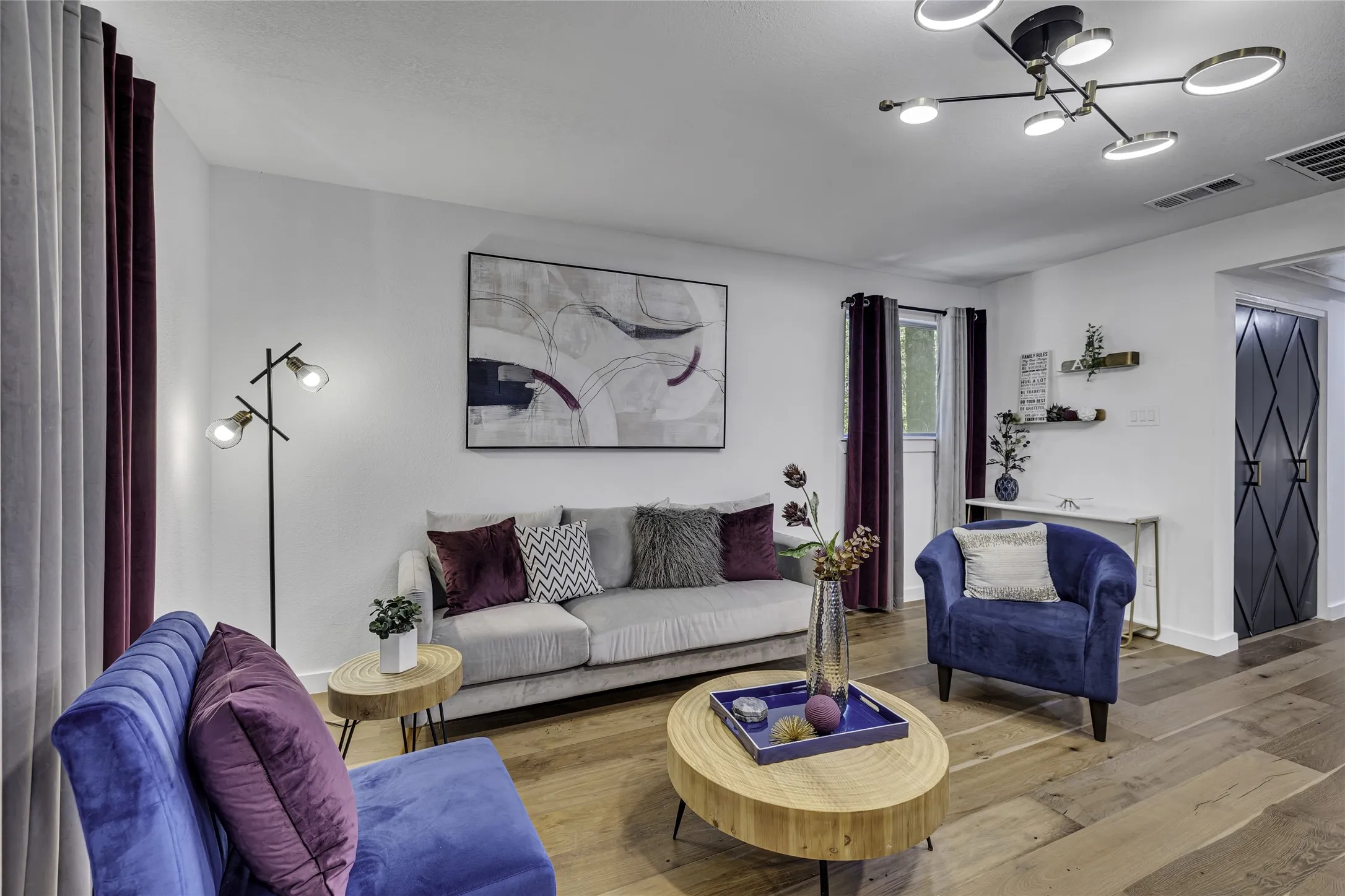 Living room featuring wood finished floors and a chandelier