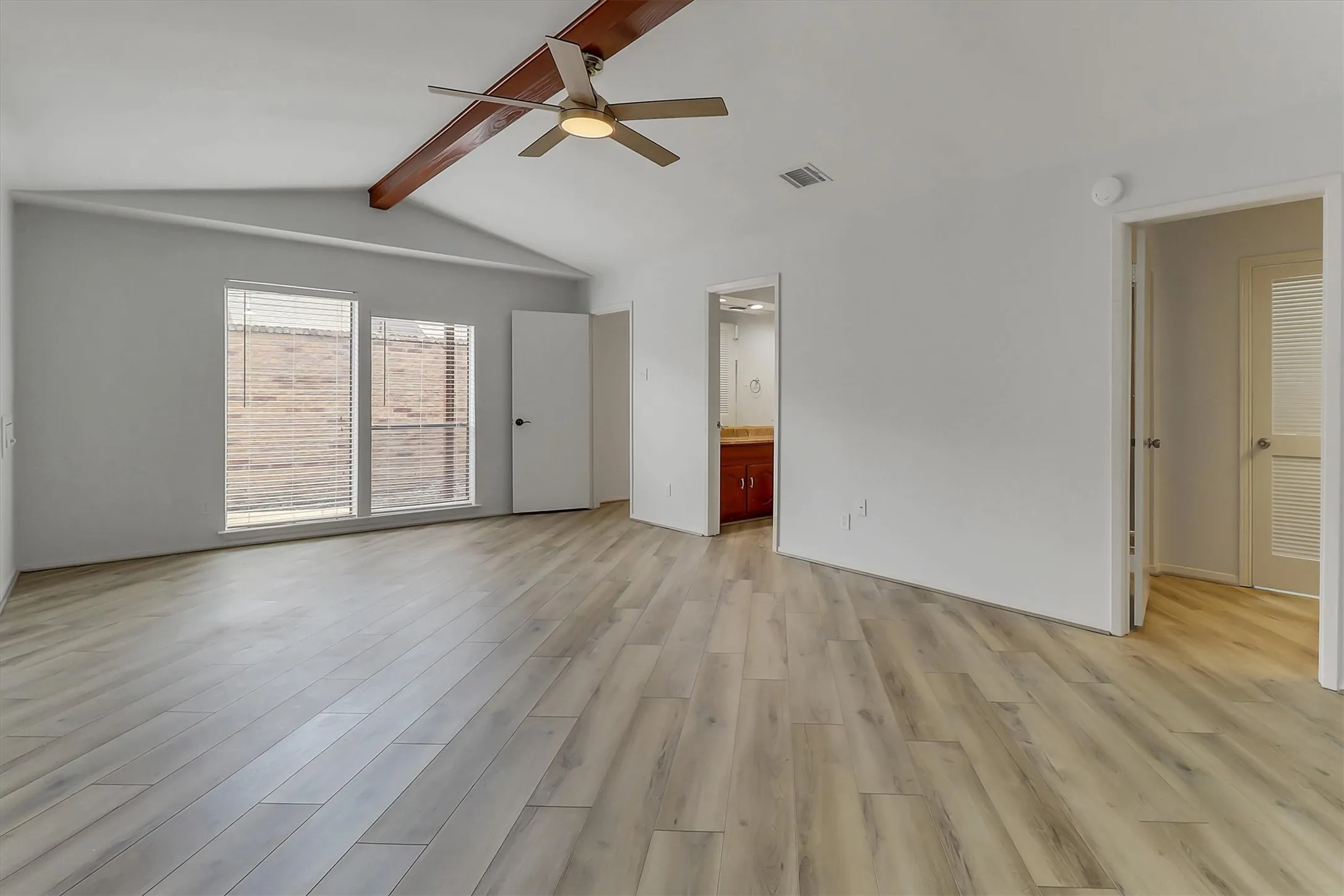 Primary bedroom with separate vanities and 2 walk-in closets