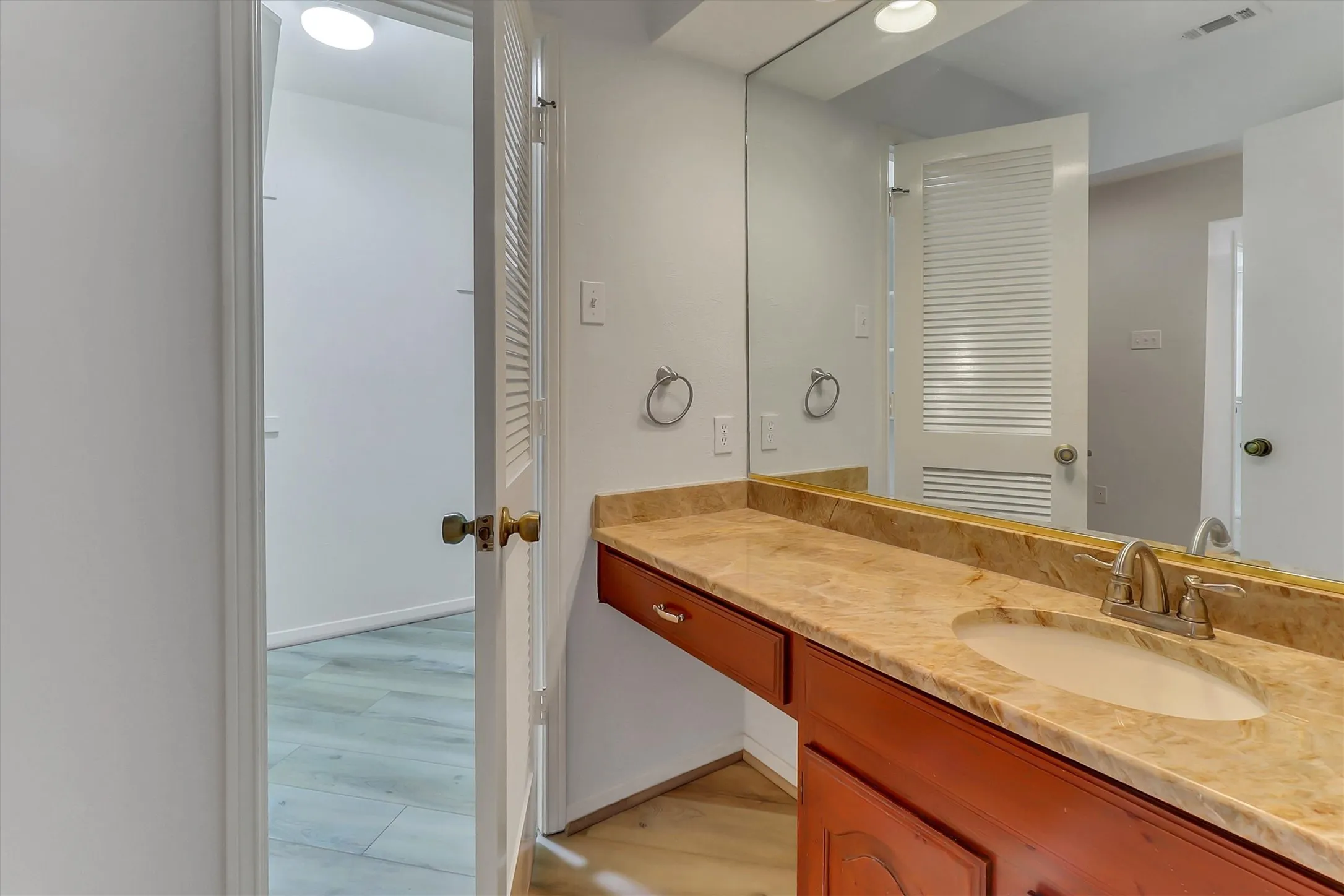 Two separate vanities with cabinets.