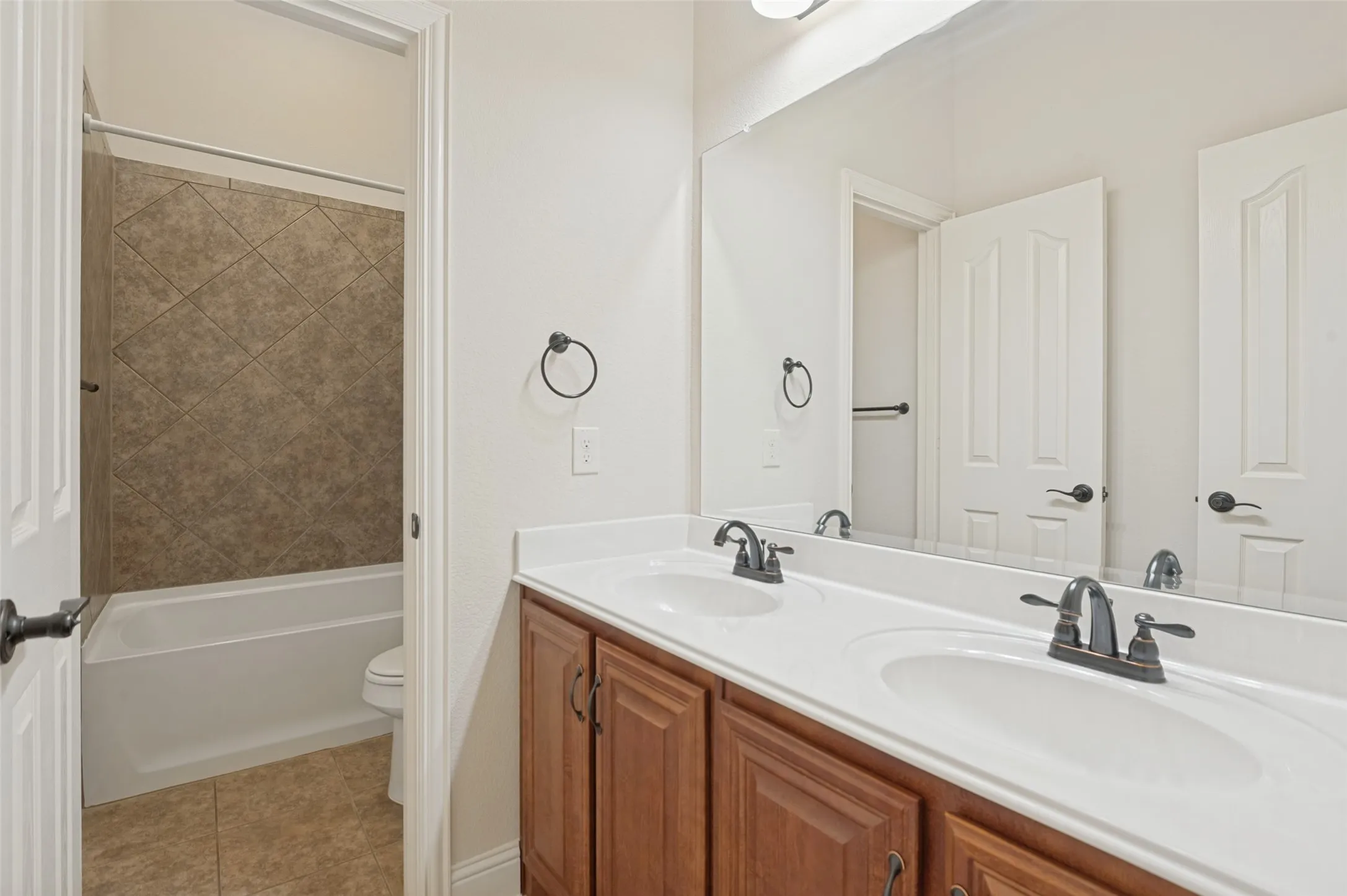 Dual vanity with integrated sinks and dark bronze hardware