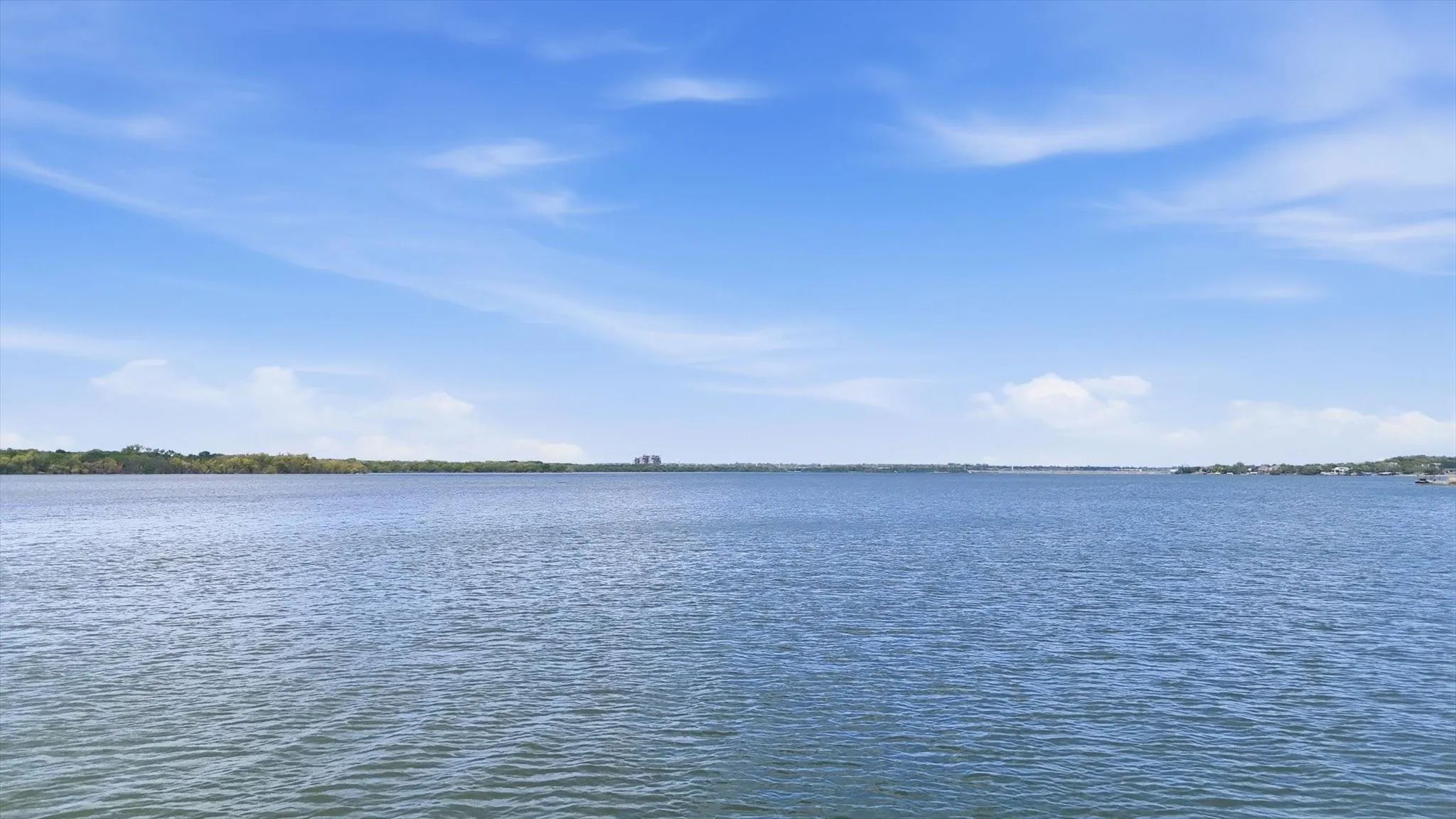 Expansive water frontage with a calm, blue waterway