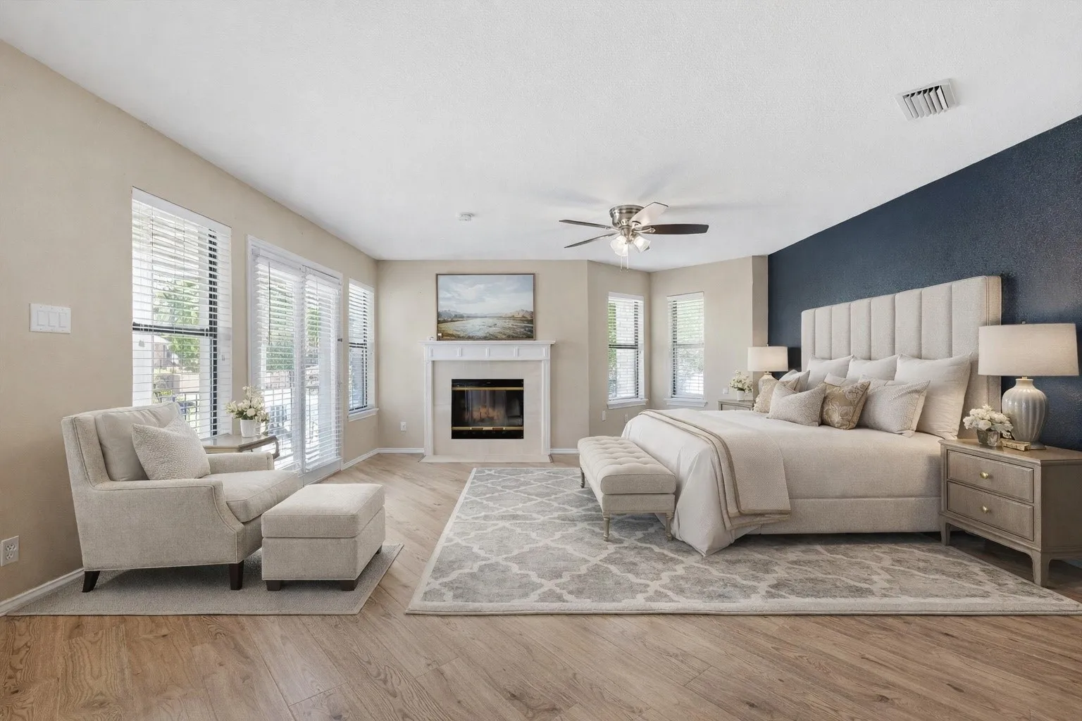 Virtually Staged Vaulted ceiling with a ceiling fan, wood-finish flooring, fireplace with a mantel, multiple windows with blinds, and recessed lighting