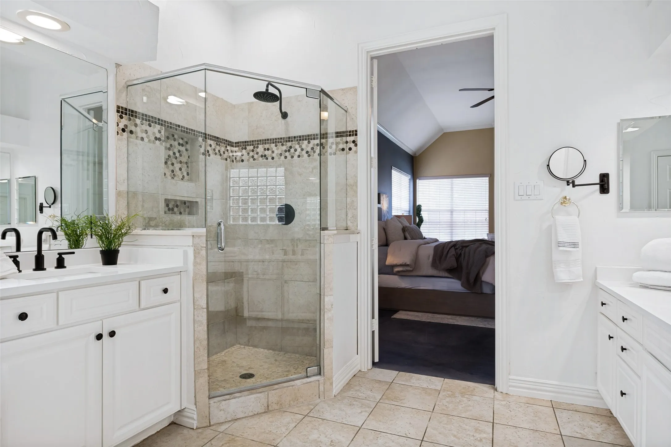 Frameless glass shower with mosaic tile accents and a built-in niche