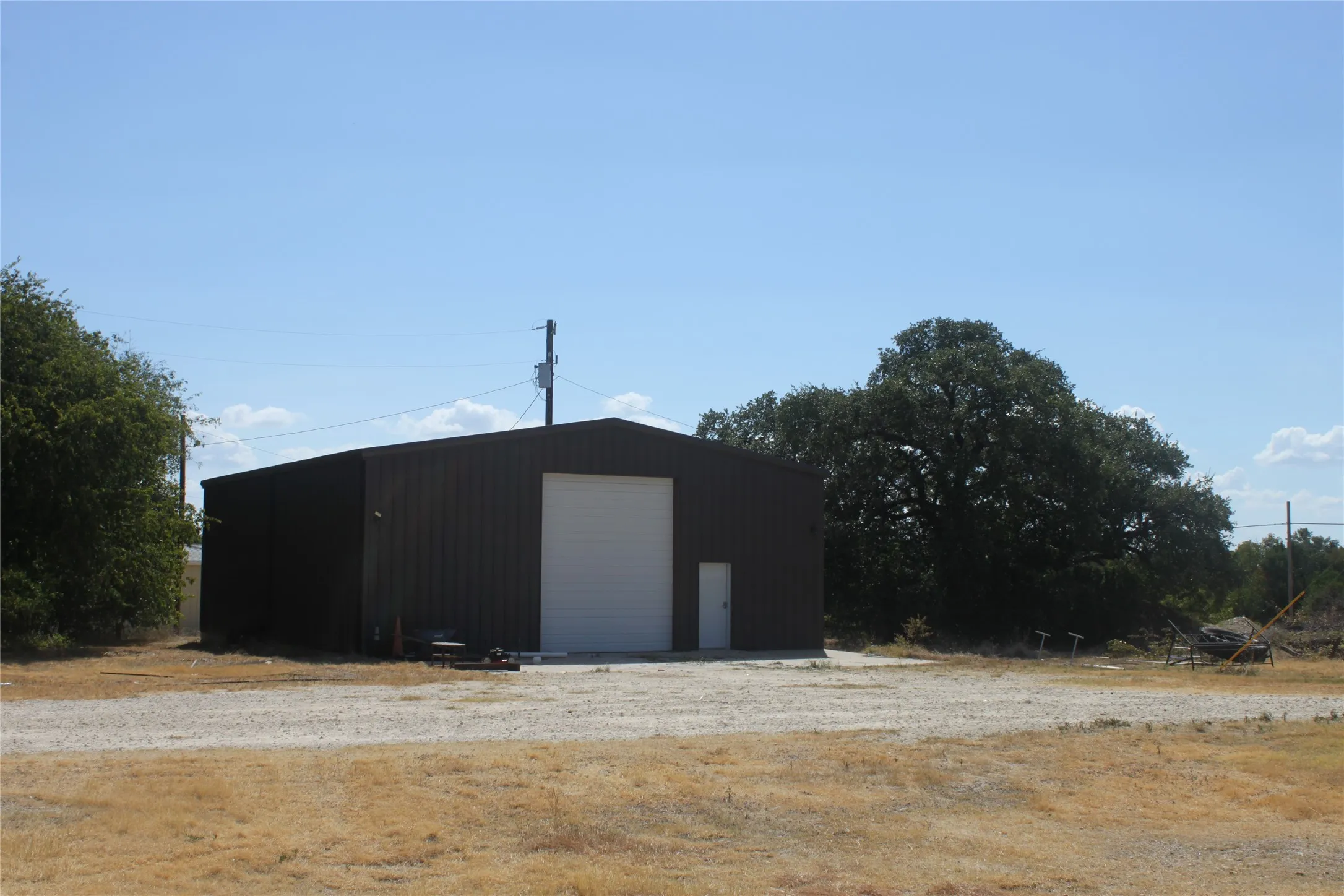 Shop building on slab with oversized roll up door