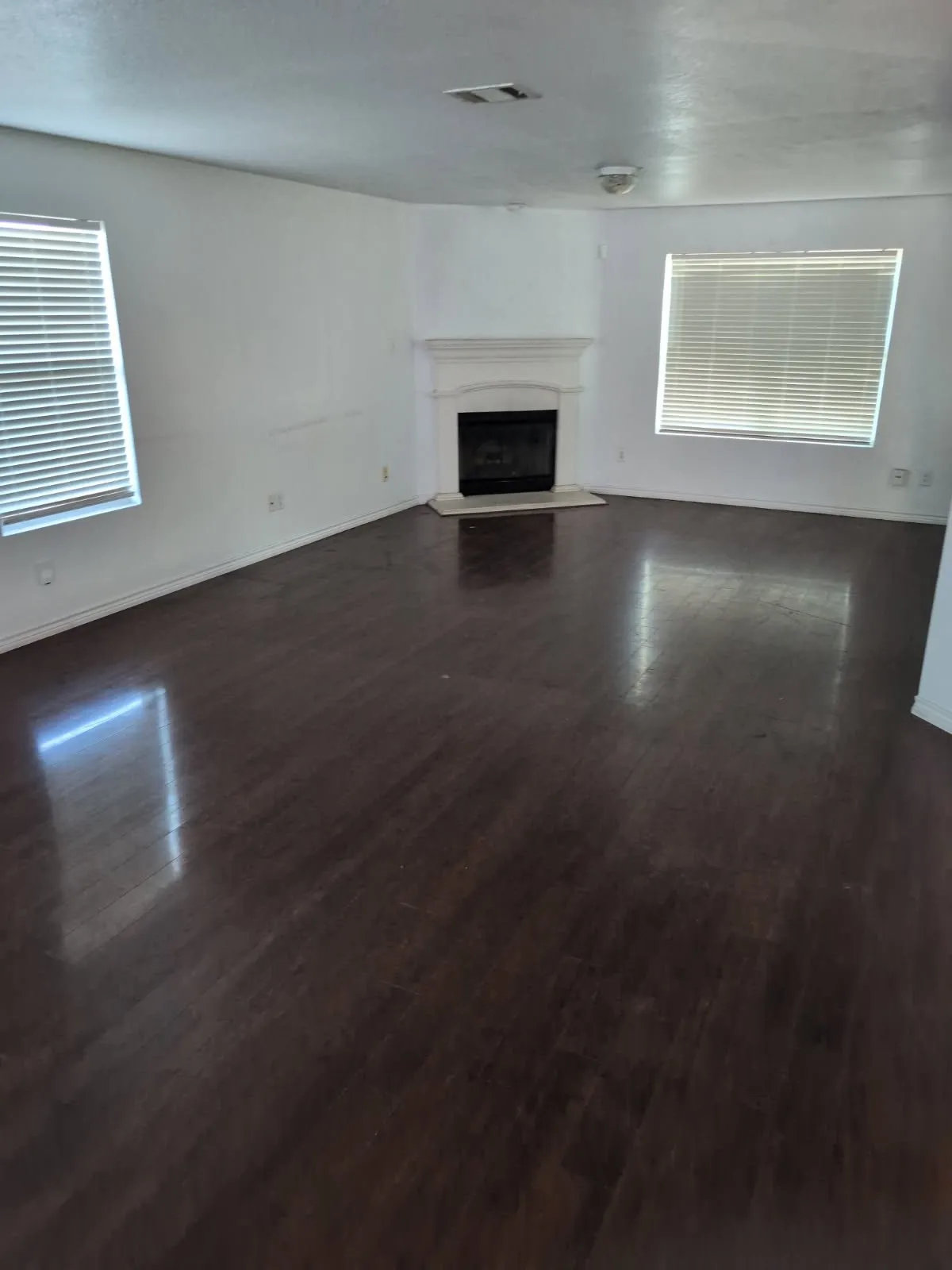 Dark wood-finish flooring complements the white walls