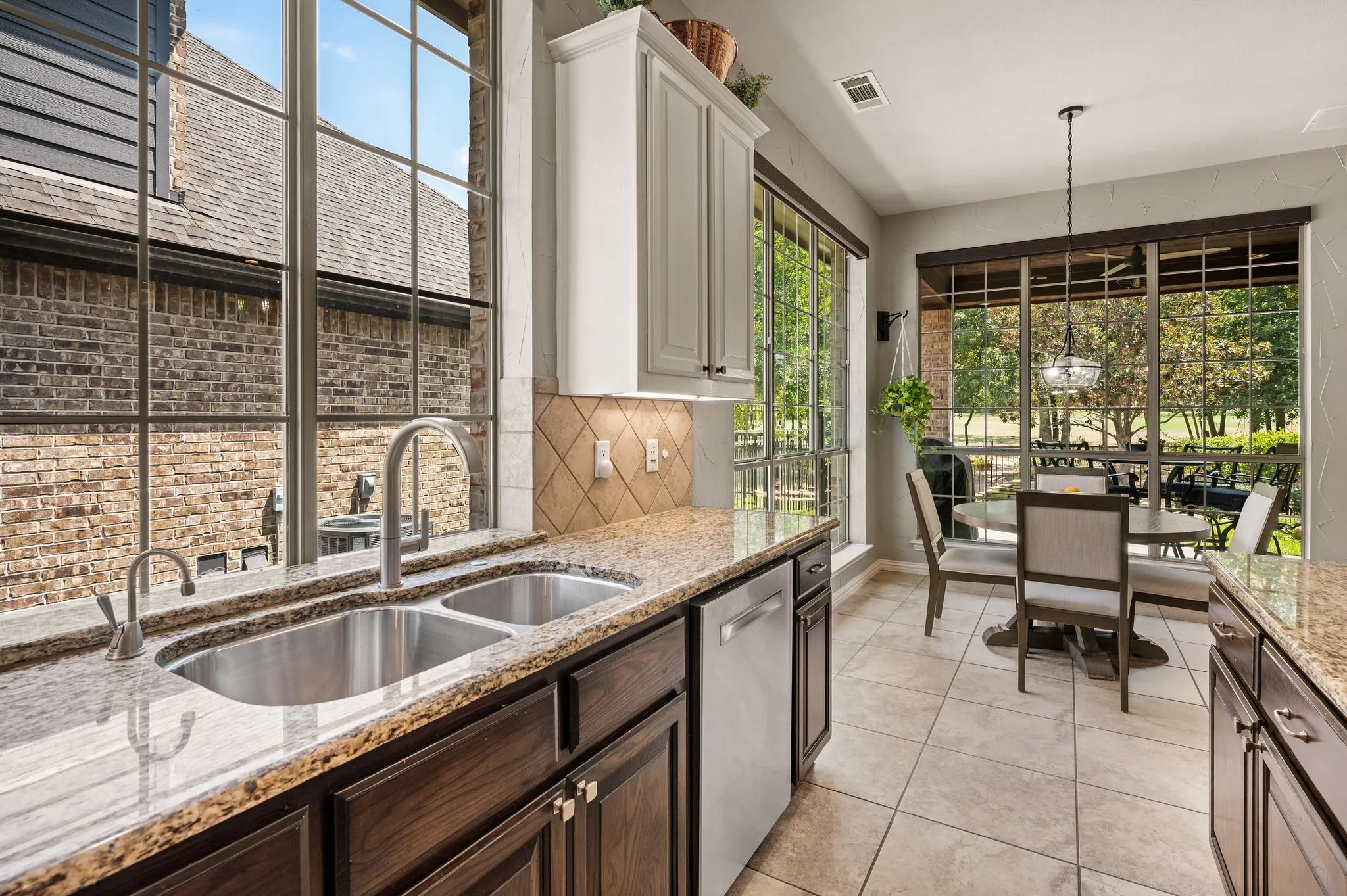 Granite countertops, a stainless steel undermount sink & abundant cabinetry make this kitchen as functional as it is inviting. All window treatments are electronic and can be programmed through a remote or Alexa.