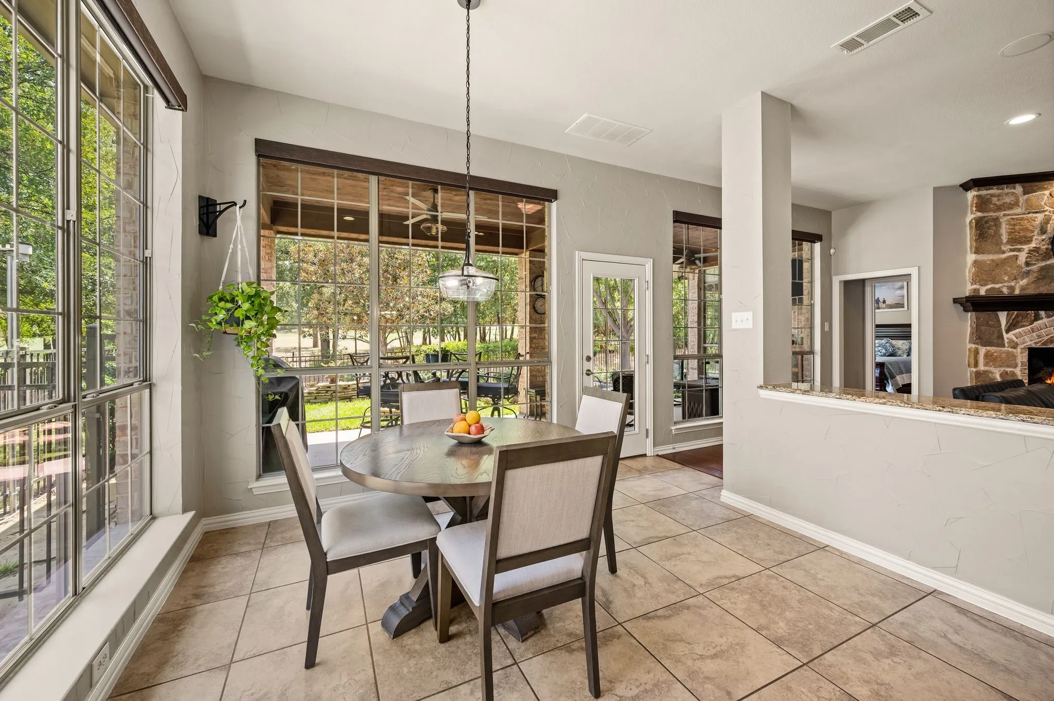 Sun-filled breakfast area offers peaceful backyard views & easy access to the covered patio.