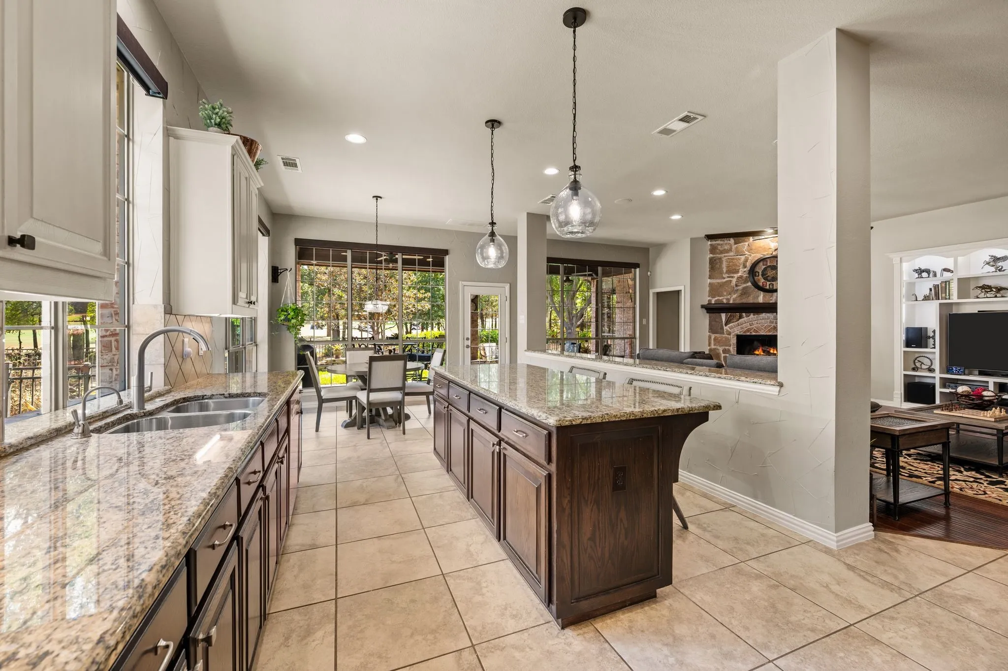 Open kitchen layout offers generous prep space, pendant lighting & seamless flow to the breakfast area and living room.