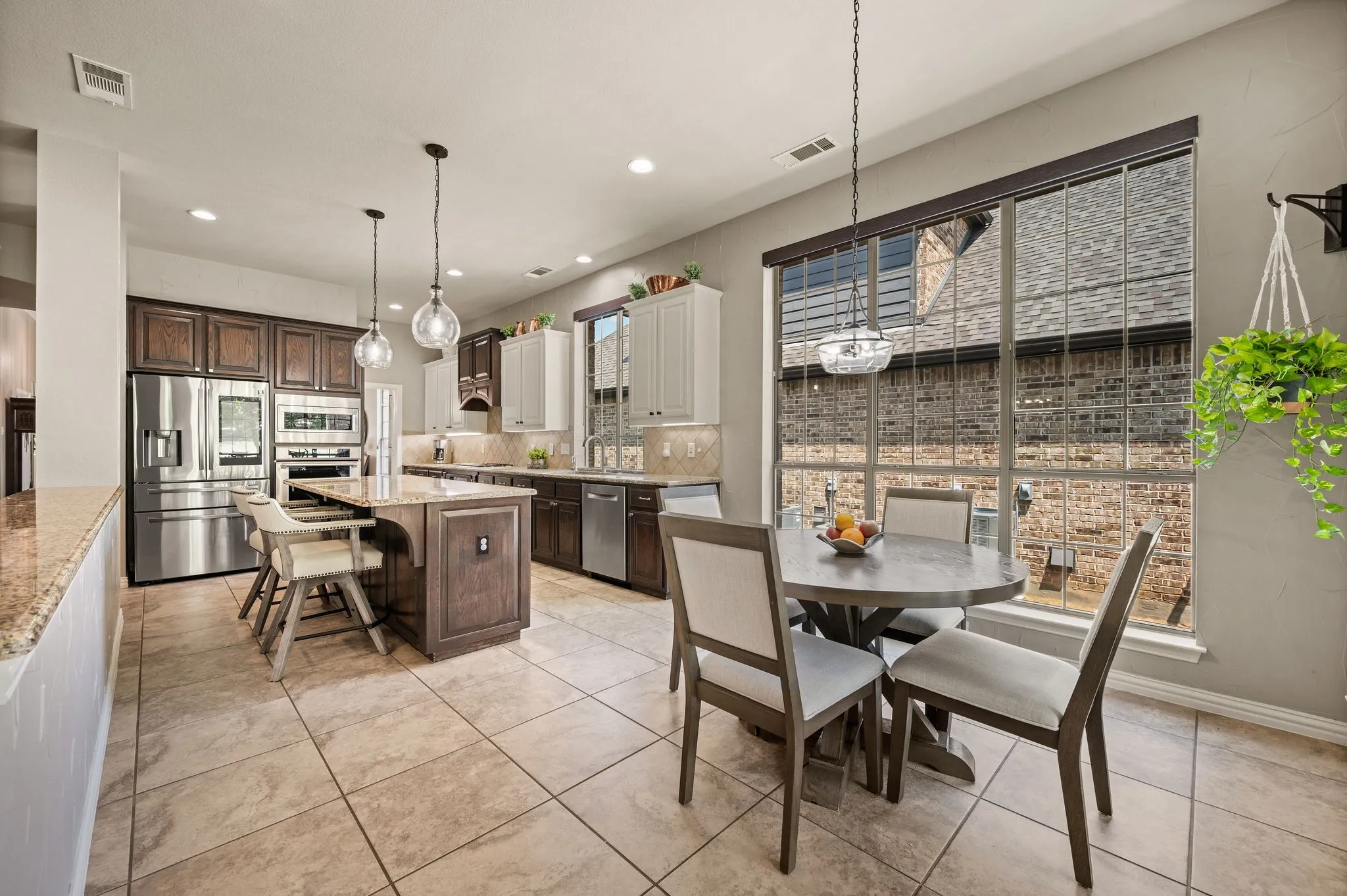 Bright breakfast area sits beside the kitchen with large windows & plenty of space for casual dining.