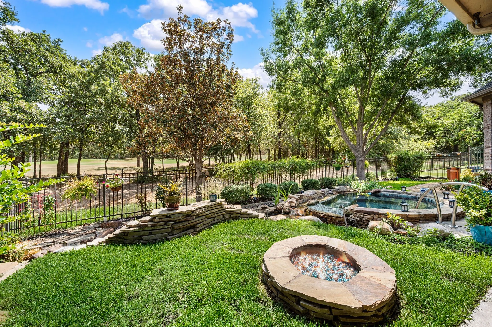 Enjoy a lush backyard setting with golf course views, a sparkling pool & built-in natural gas fire pit.