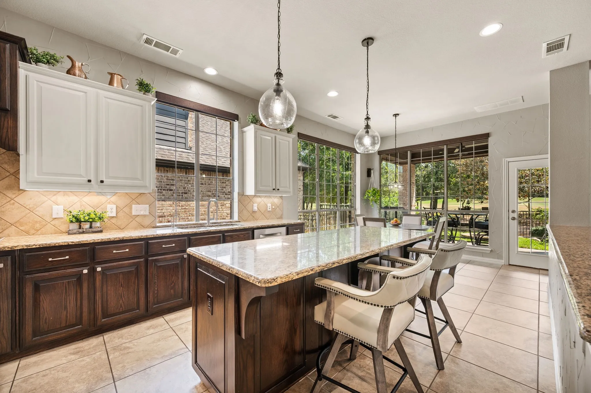 Impressive kitchen features granite countertops, extensive cabinetry & an oversized island with bar seating.  Electrical outlets present at either end of the breakfast bar.
