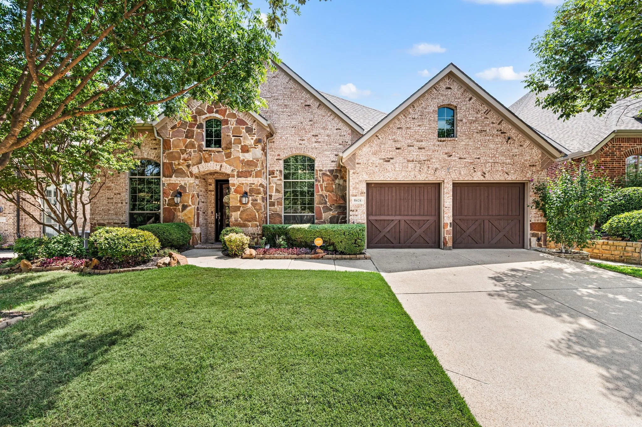 Welcome to 8424 Jefferson Way, featuring beautiful brick & stone architecture, lush landscaping & a 2-car garage.