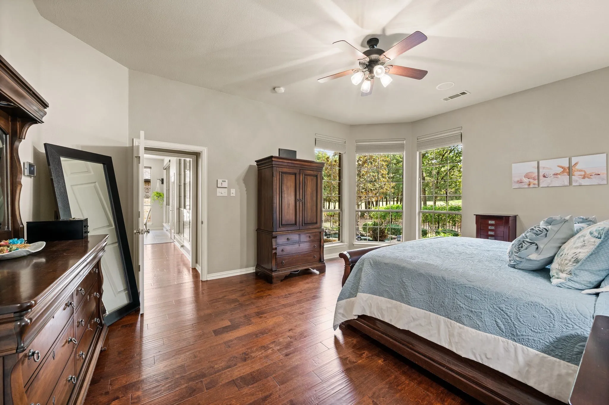 The primary bedroom offers generous dimensions, abundant natural light & lovely backyard views.
