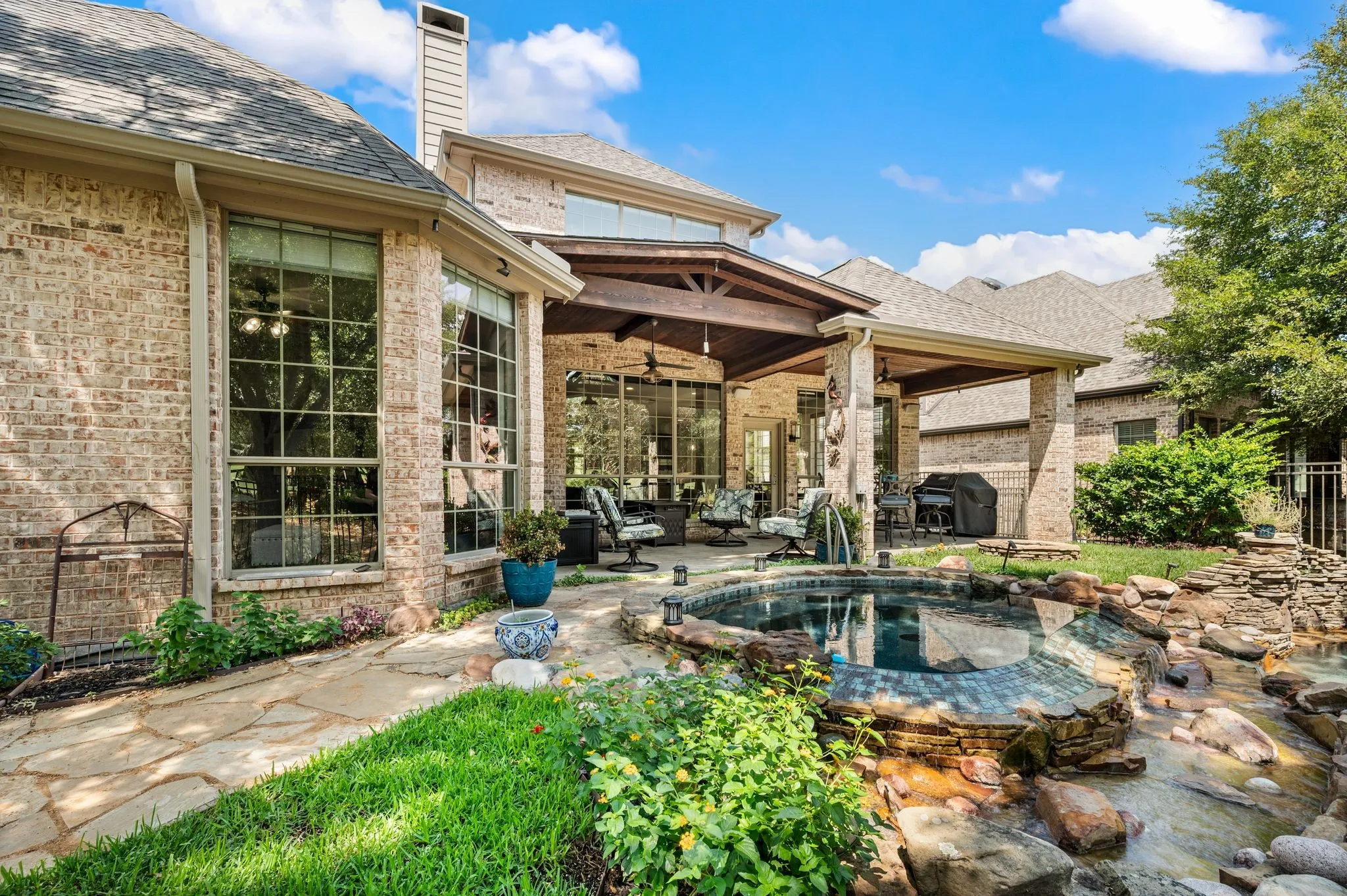 Lush landscaping surrounds the private pool along with custom landscape lighting for the evenings!