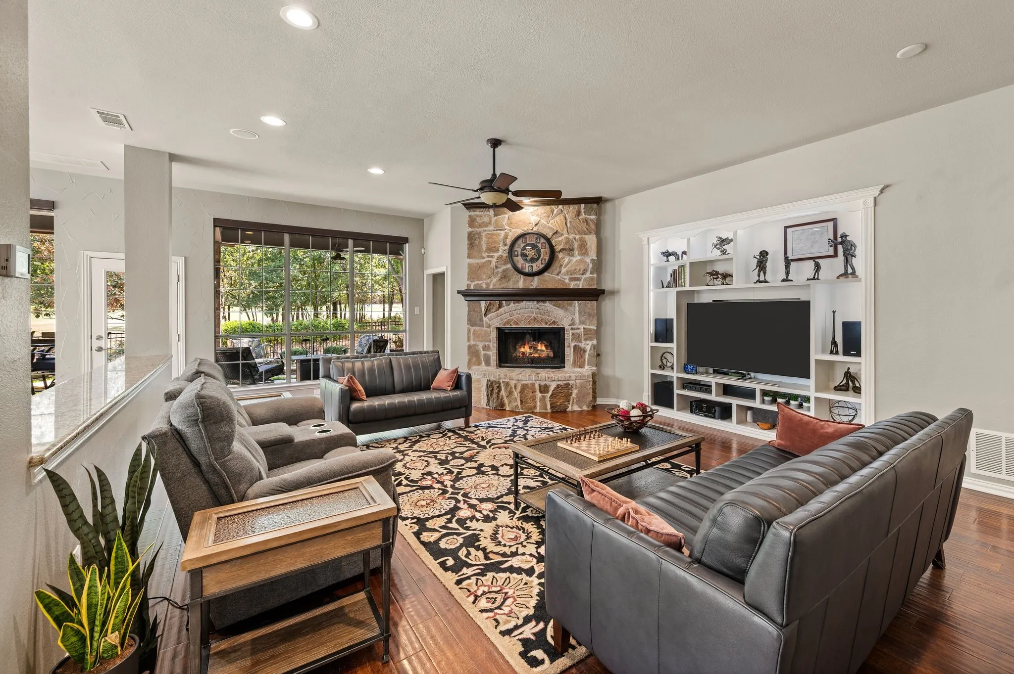 Built-in entertainment cabinetry, abundant natural light & a cozy fireplace make this living room perfect for gathering. Also notice the recessed built in area for the TV, thus making your family room feel larger.