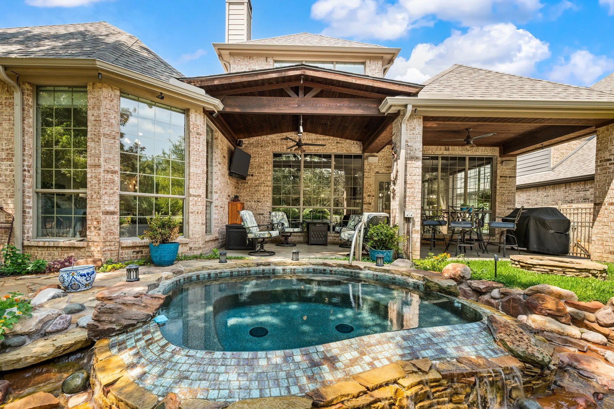 Relax beside the sparkling pool while enjoying the impressive covered patio designed for year-round entertaining.