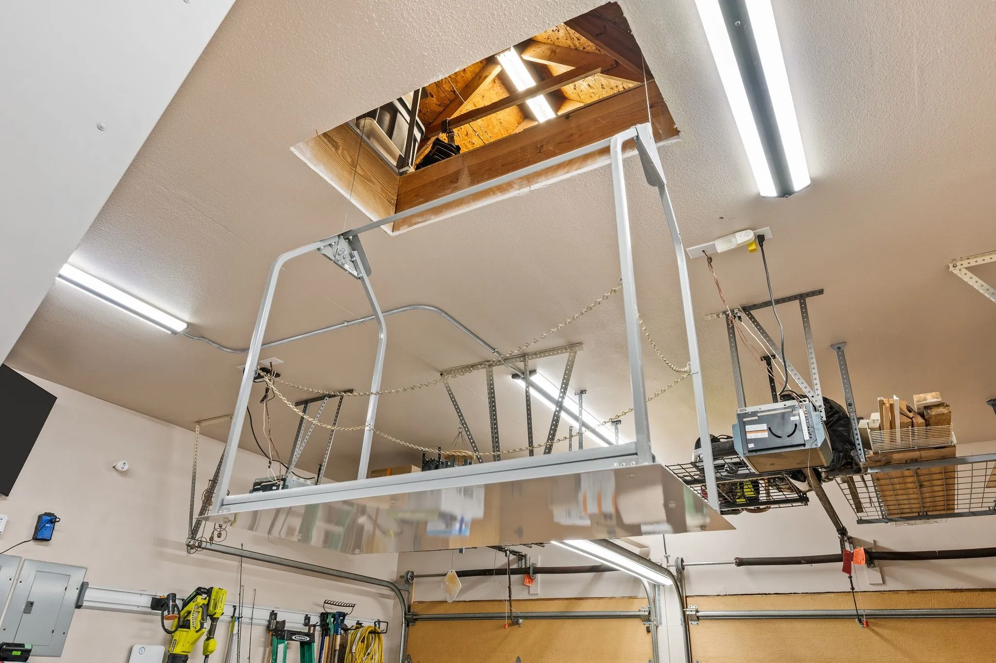 Attic elevator provides convenient access for moving stored items between the garage & attic.