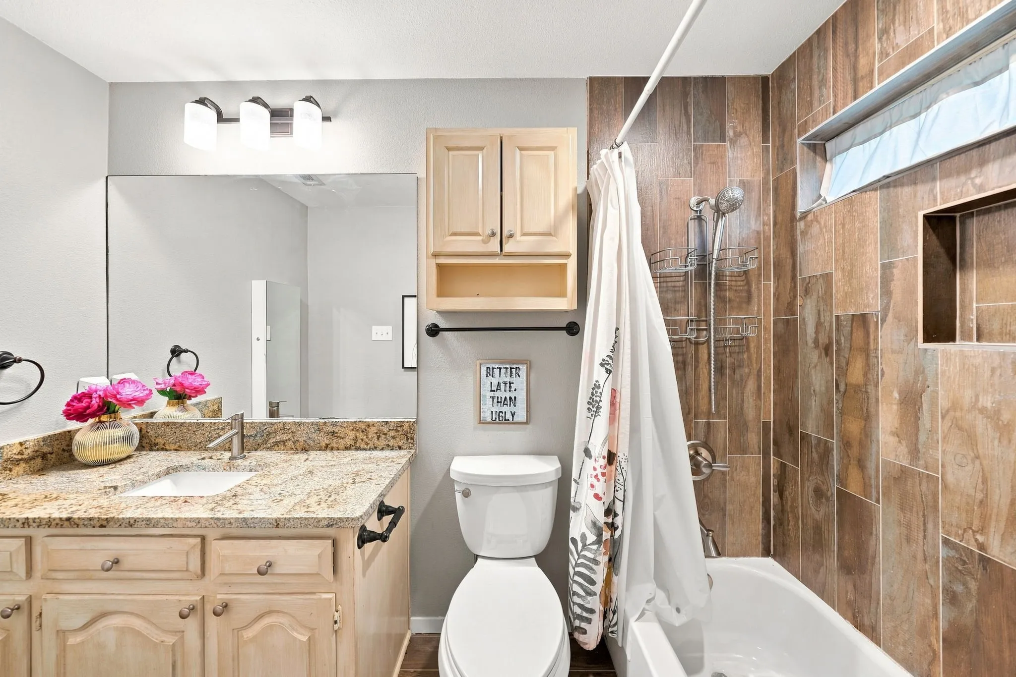 Vanity with a granite countertop, undermount sink, and brushed nickel faucet