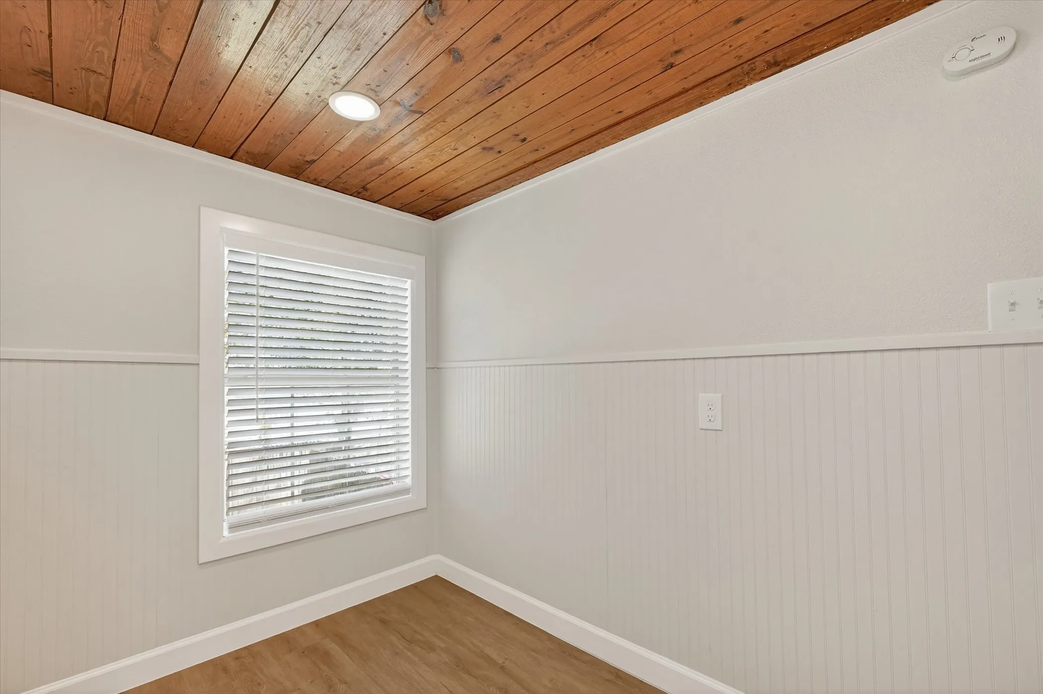 Wood-finish plank ceiling with recessed lighting