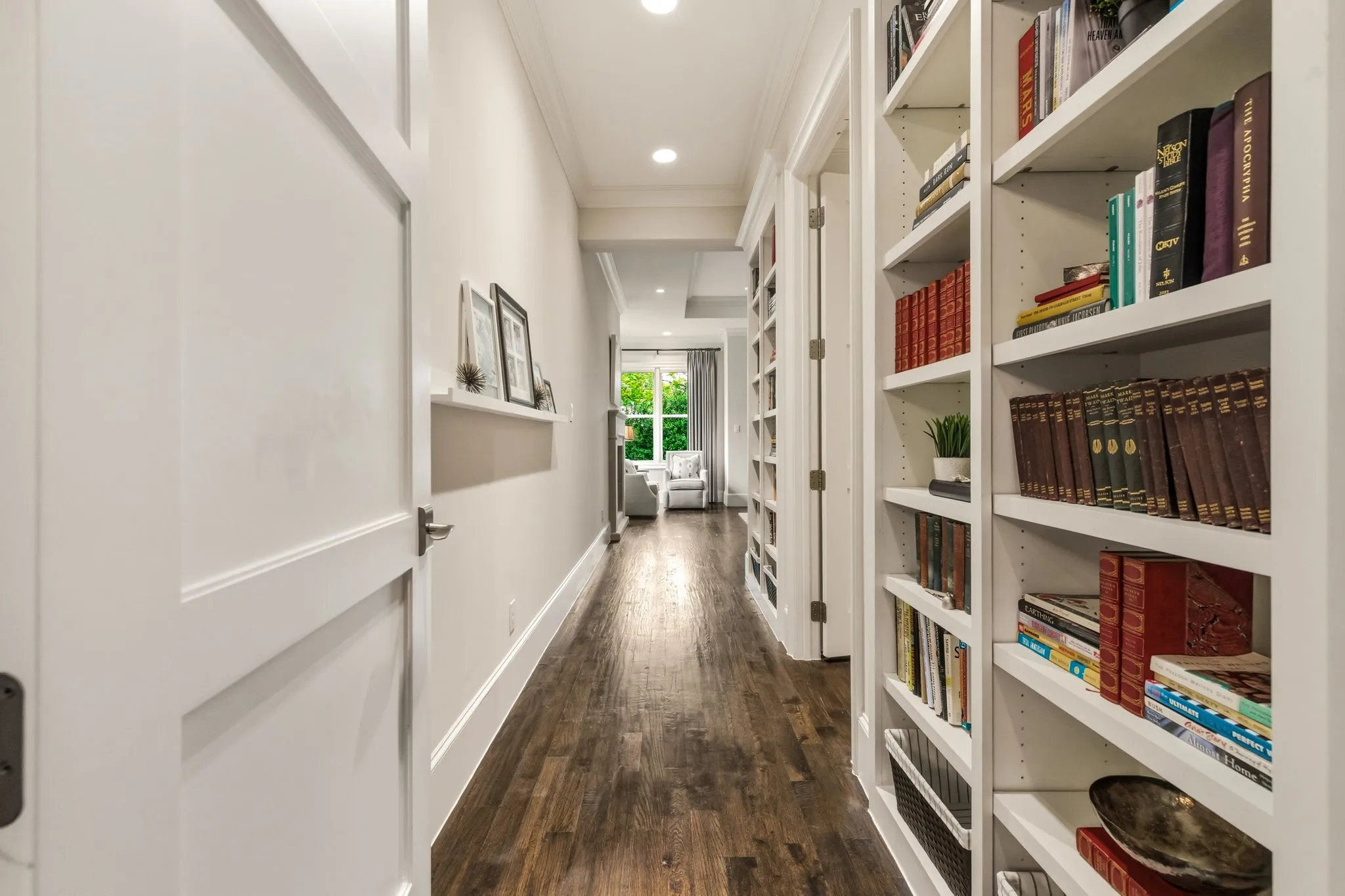 Hallway and bookshelves leading into primary bedroom.
